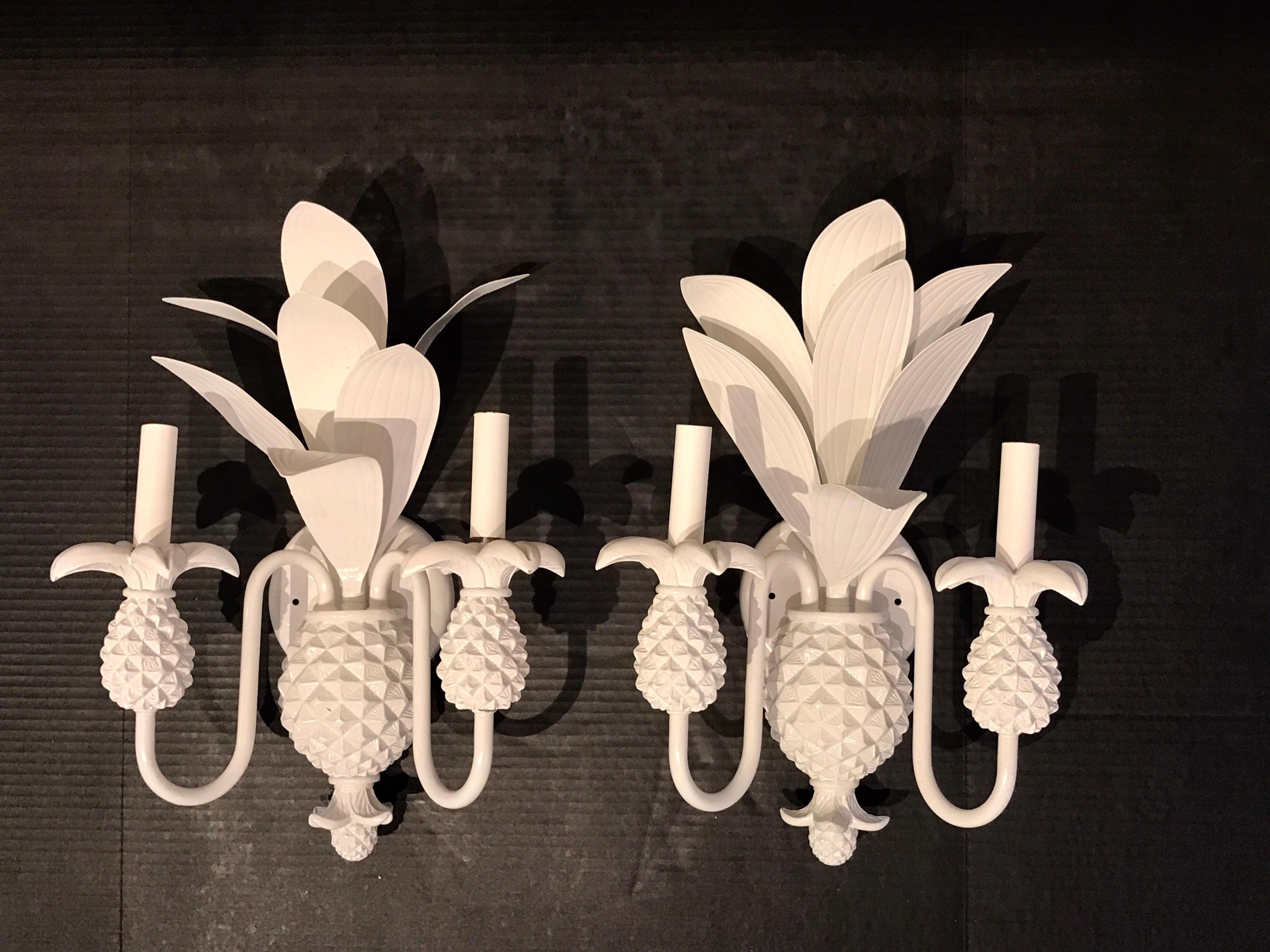 Pair of Hollywood Regency two-light pineapple sconces, each one of lacquered tole, newly wired.