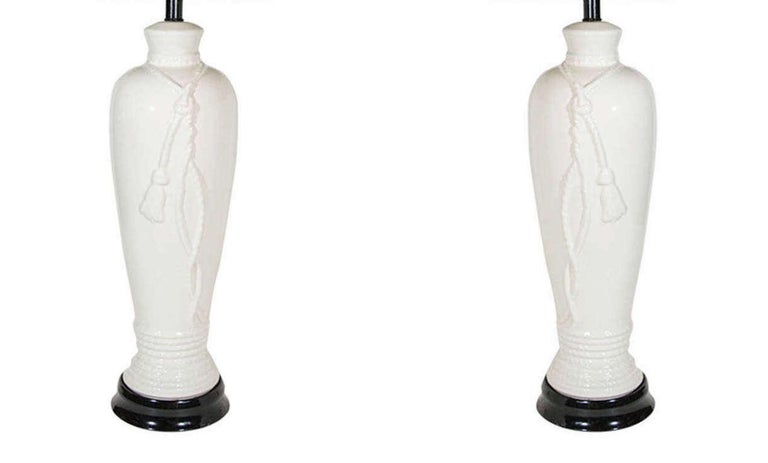 American Pair of Hollywood Regency Porcelain Lamps with Rope and Tassel Design For Sale