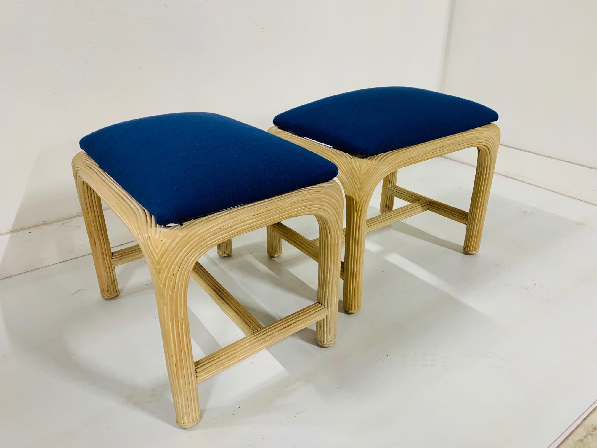 Pair of Hollywood Regency, reed upholstered benches with blue upholstered seats.