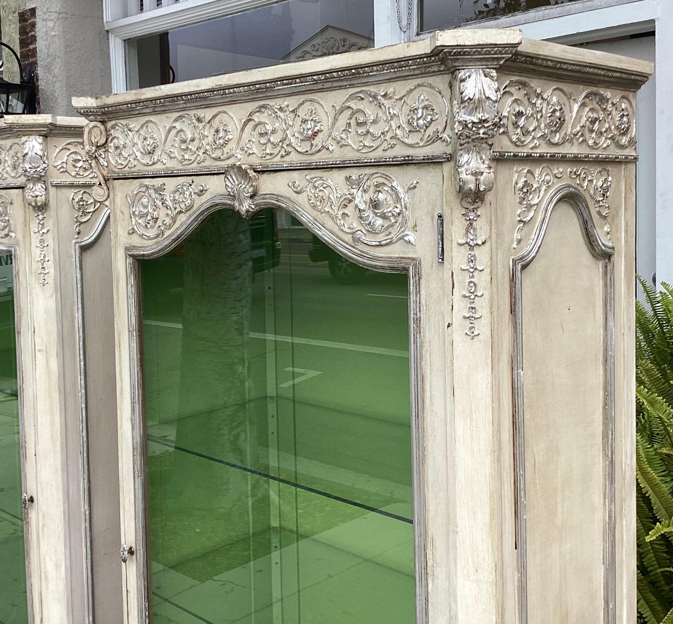 20th Century Pair of Hollywood Regency Silver Giltwood & Paint Decorated Display Cabinets