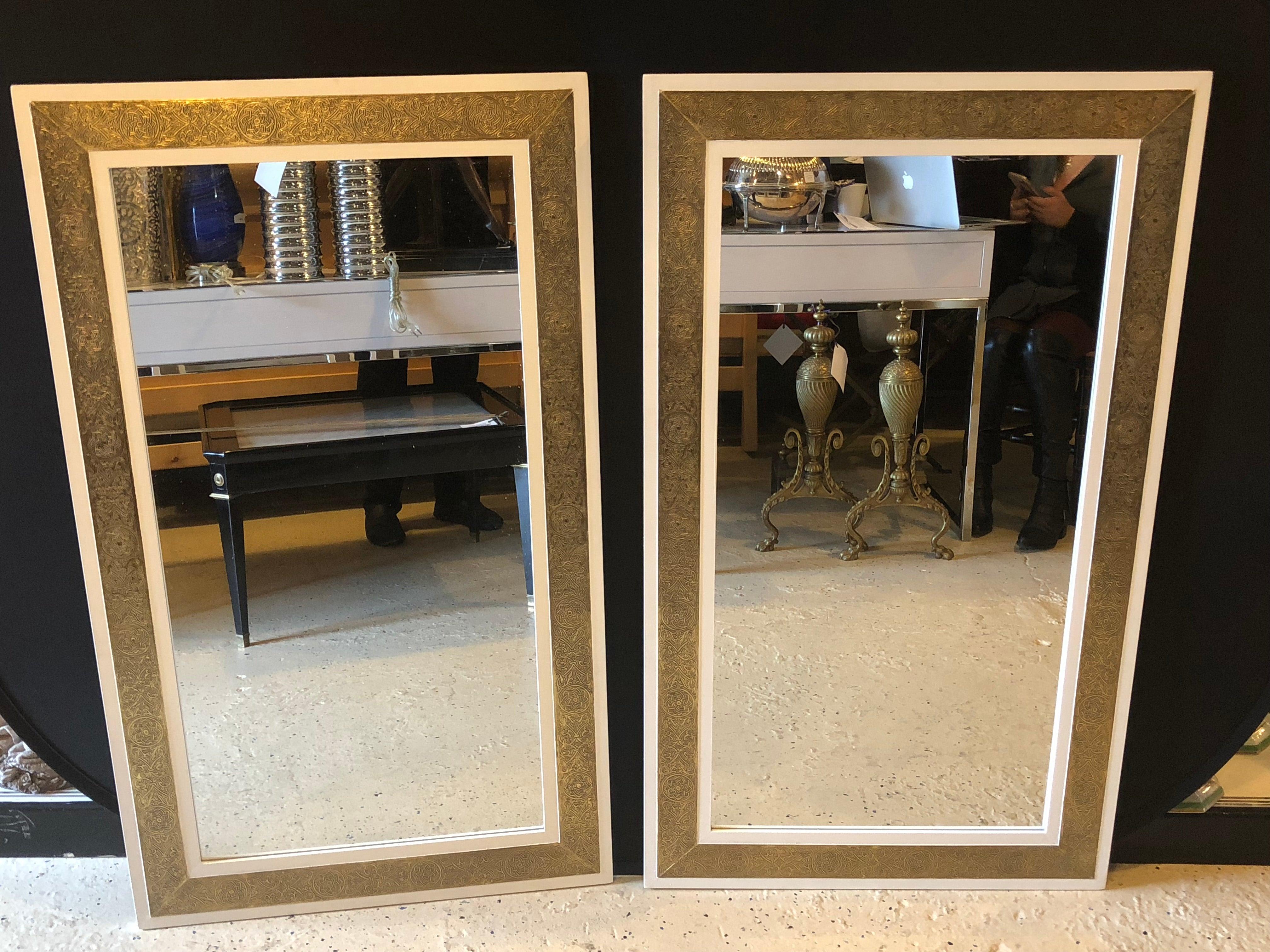 A pair of elegant handcrafted brass on white wood framed console or pier mirror. The brass frame features handcrafted opulent design. The Hollywood Regency pair of mirrors are a delightful centre piece in any living environment and design.

Can be