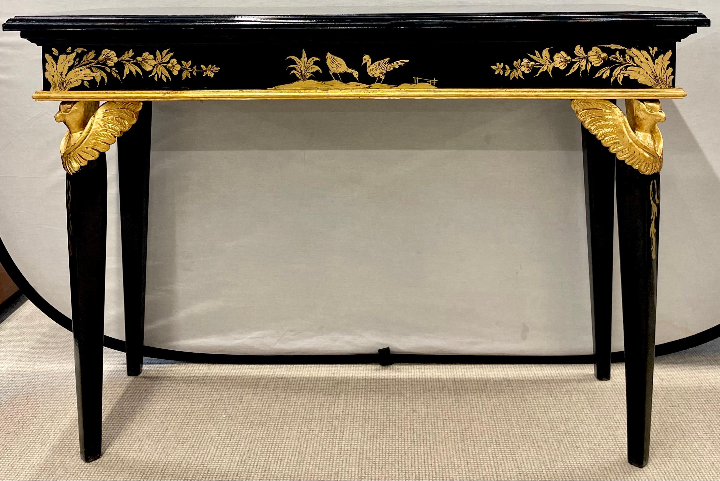 Pair of Hollywood Regency Style Ebony and Gilt Decorated Sofa Console tables. The pair having Figural winged birds on the corner of the legs.