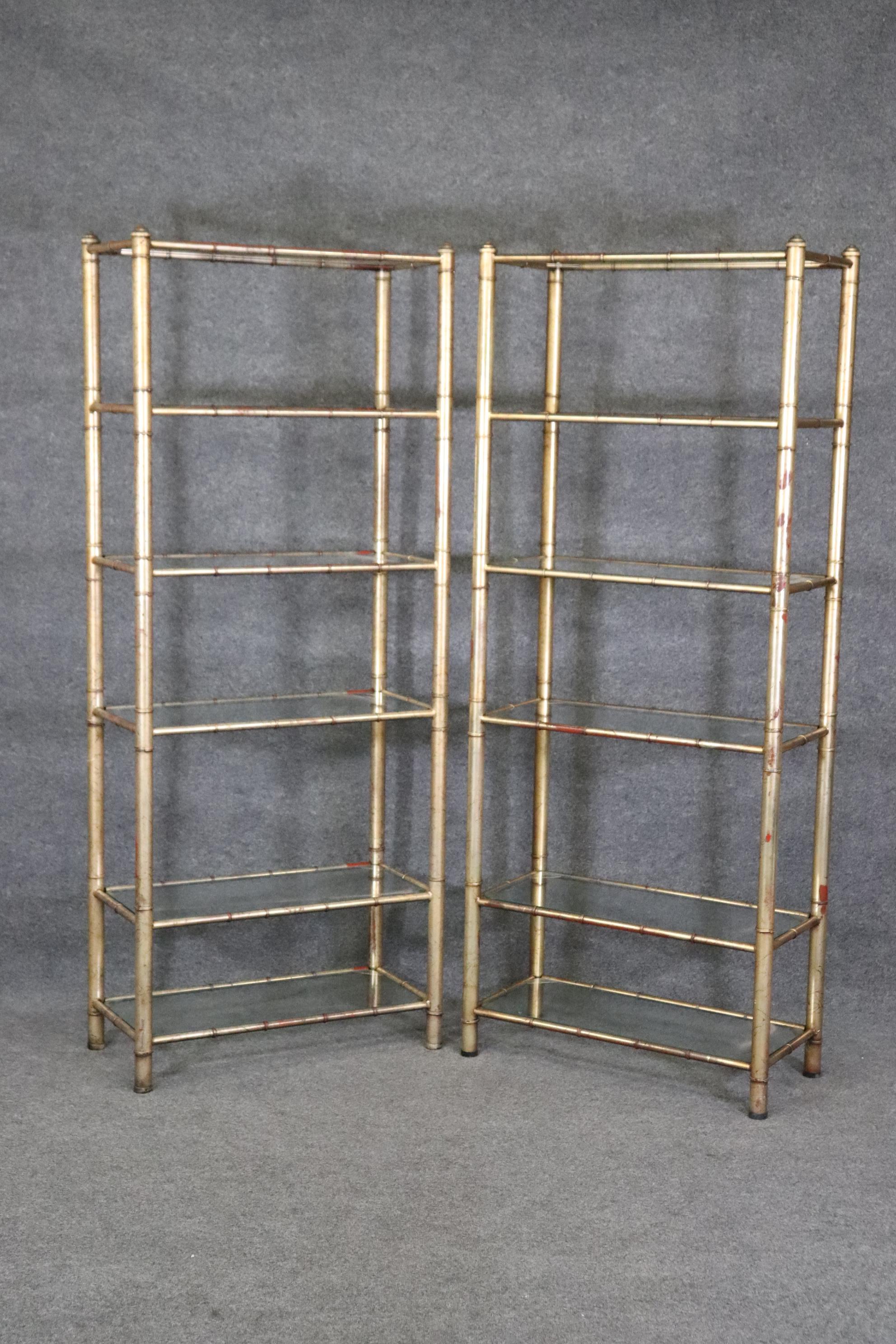 This is a stunning pair of Hollywood Regency style faux bamboo etageres. They have their original crackled gilded finish and glass shelves. The etageres are in good vintage condition and have no major flaws to speak of. The etageres measure 75 tall