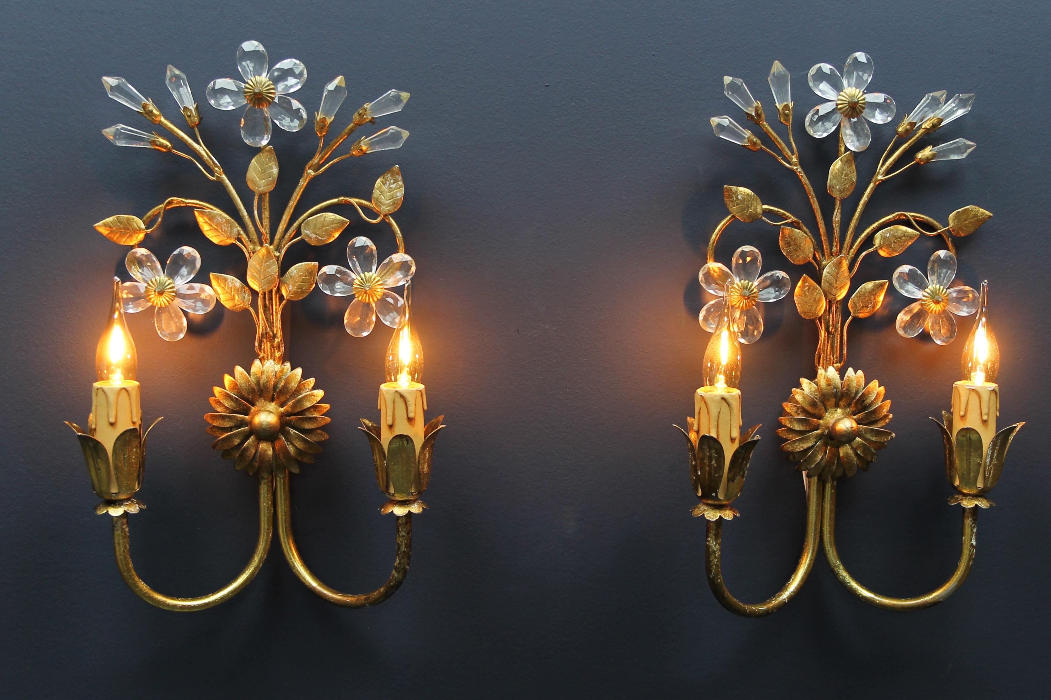 Hollywood Regency style Italian gilt metal and glass flower double wall lamps, set of two.
A beautiful set of two gilt metal wall lights with glass flowers and buds, gilt metal leaves. Each sconce has two arms with sockets for an E14-Size light