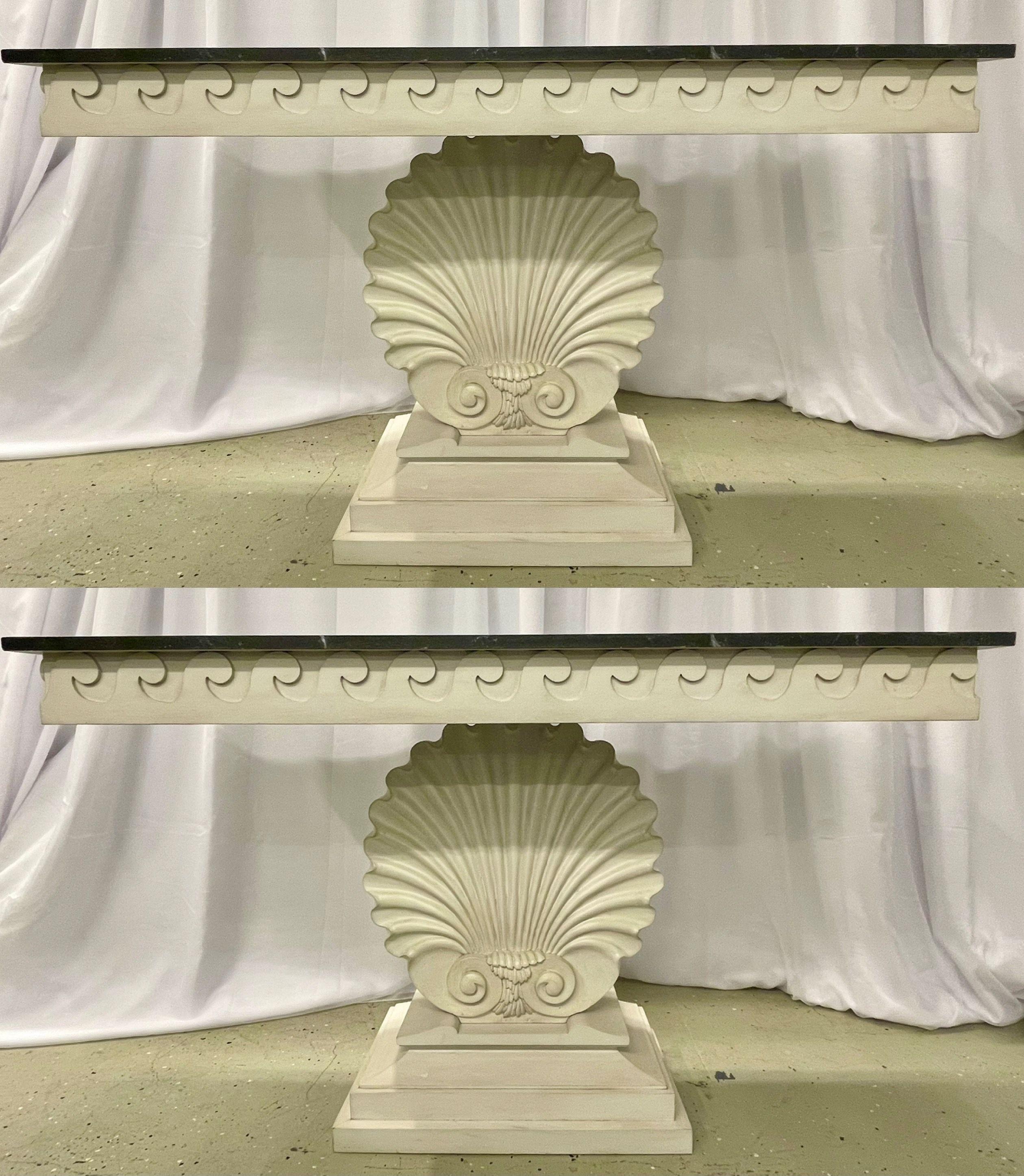 Pair of Hollywood Regency Style Shell From Console Tables. Each having a Faux Marble Top over a swirl carved apron supported by a large center seashell carved pedestal on a rectangular step up base. IPES