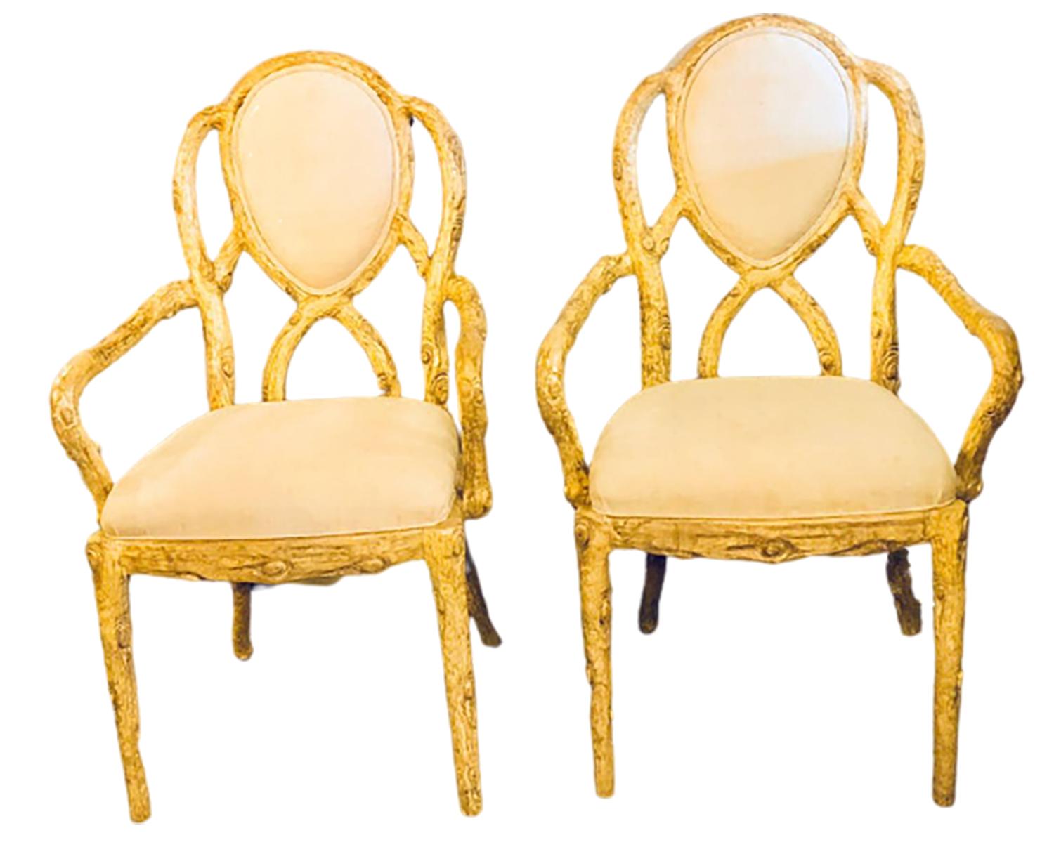 Pair of Hollywood Regency style tree trunk form designed armchairs. Each of these newly upholstered armchairs have been designed to look as though they were carved from a tree branch. The pair having comfortable sets and back rests with flowing
