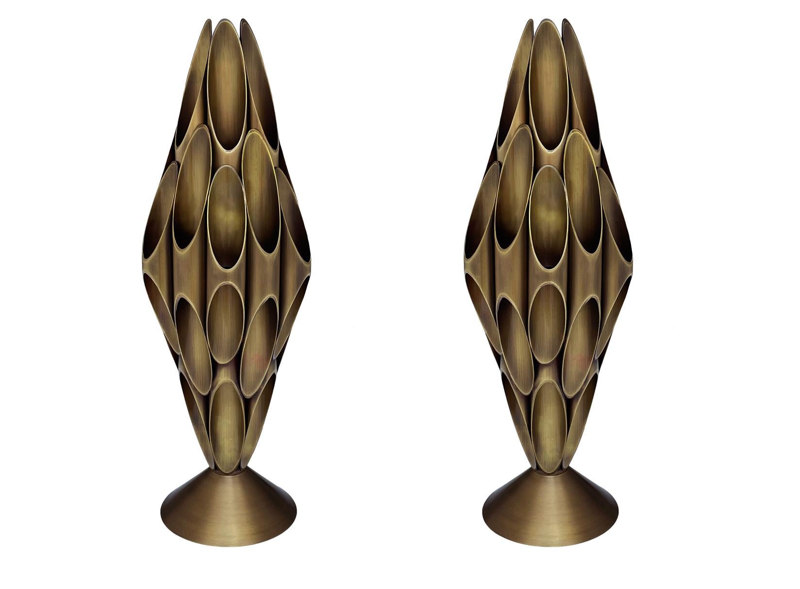A pair of striking & chic tubular table lamps made by Designline. These feature heavy all brass construction. Nice warm accent lighting. Takes one standard bulb. Cord is very long with built in switch.
