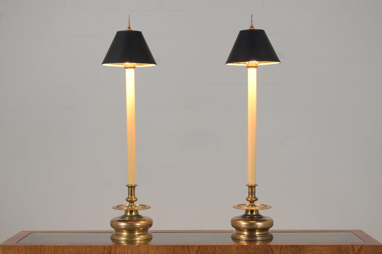 Elevate your interior ambiance with our dazzling pair of table lamps from the 1960s, impeccably reimagined in the Hollywood Regency Style. Hand-crafted from brass, these lamps stand as a testament to the timeless allure of masterful craftsmanship,