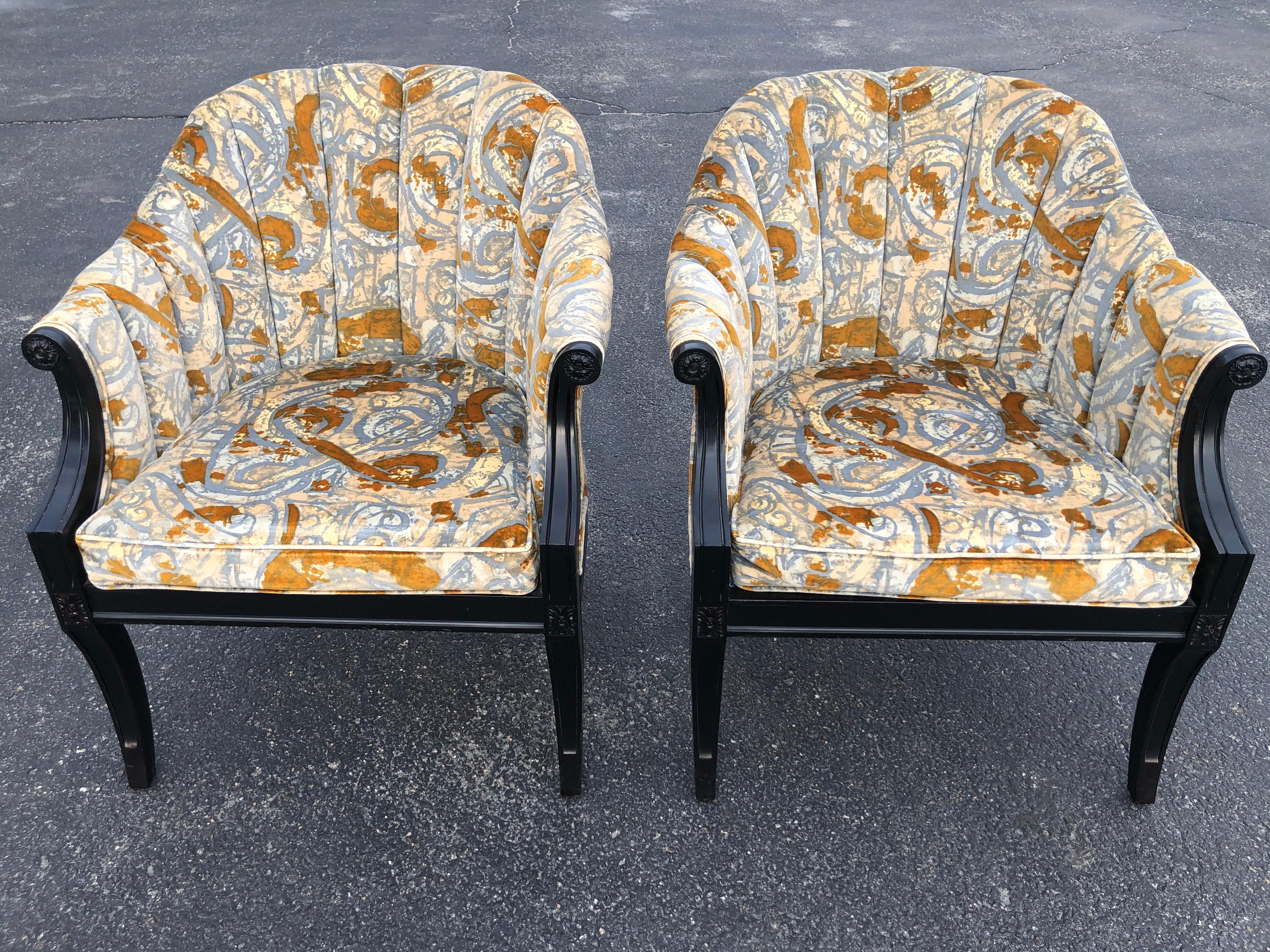 Pair of Hollywood Regency velvet chairs. Dramatic black wooden trim with what we believe to be Jack Lenor Larsen velvet upholstery. Gray blue caramel and off white tones make up this comnpostion. No need to recover. In very good condition.