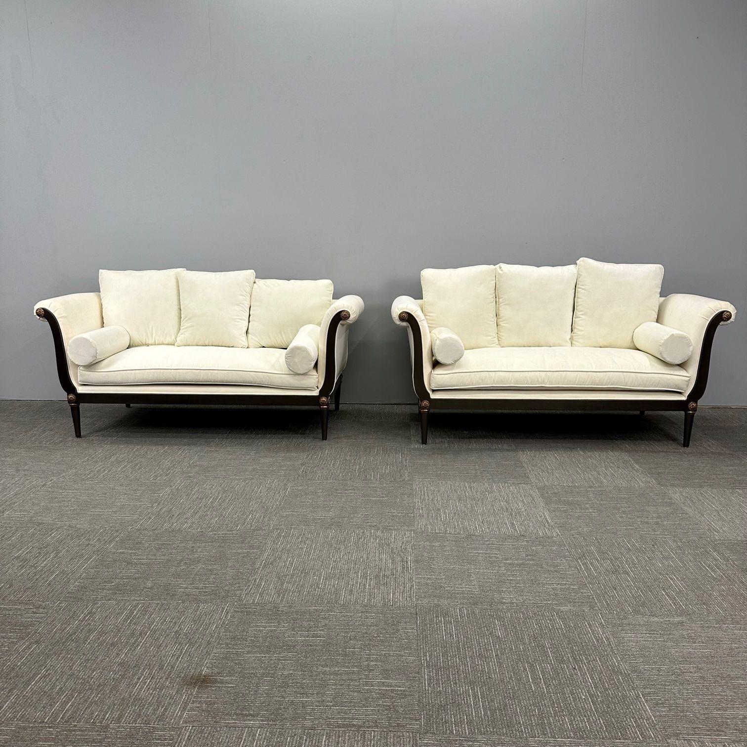 Pair of Hollywood Regency Vesey Style Sofas / Settee, Wood Frames with Bronze Mounts, New 
 
Pair of Directoire style sofas or settees having solid wooden frames. These seating arrangements feature wood frames and gilt bronze florets, with straight