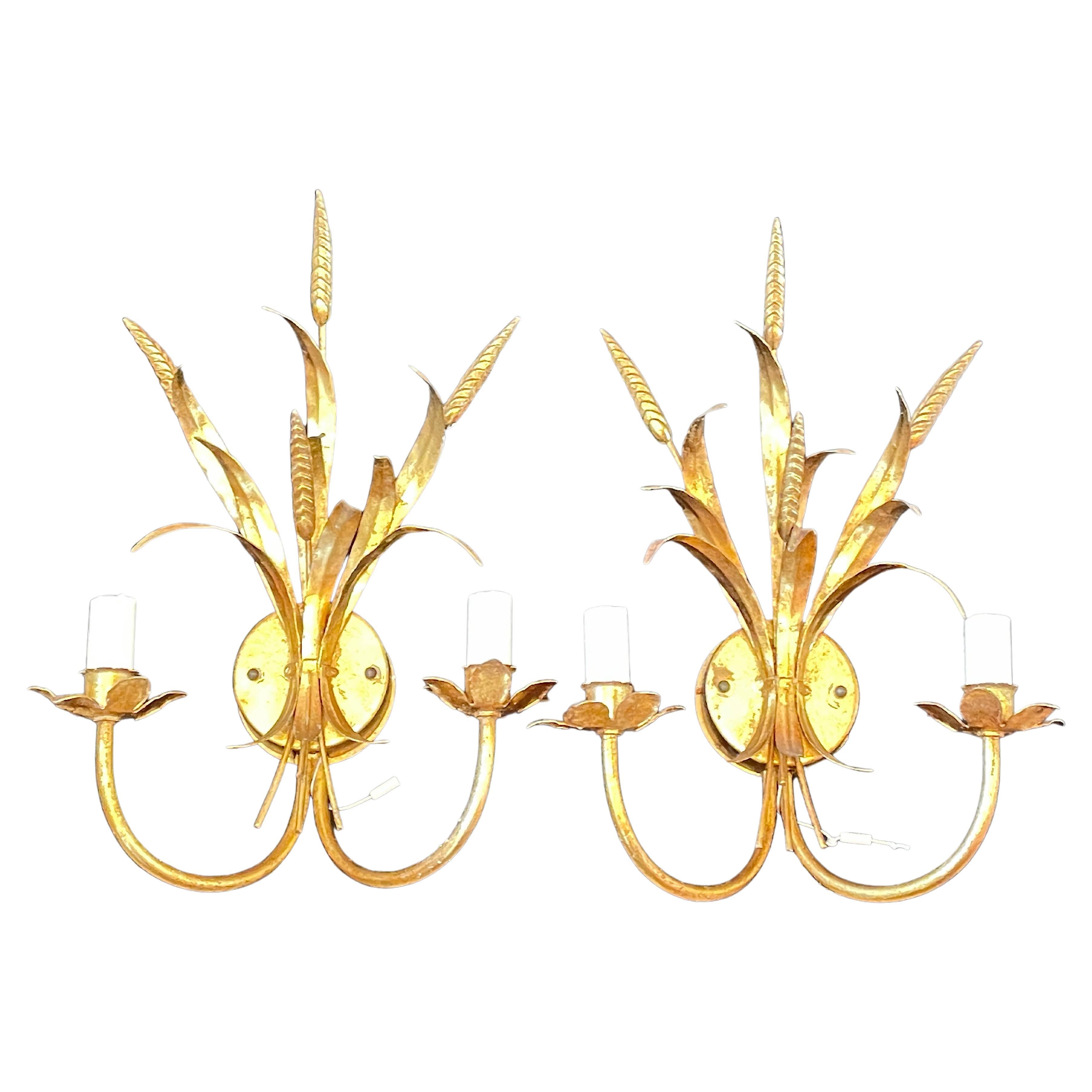 A pair Hollywood Regency mid-century gilt tole wheat sheaf sconces, each fixture requires two European E14 candelabra bulbs, each bulb up to 40 watts. The wall lights have a beautiful patina and gives each room a eclectic statement.