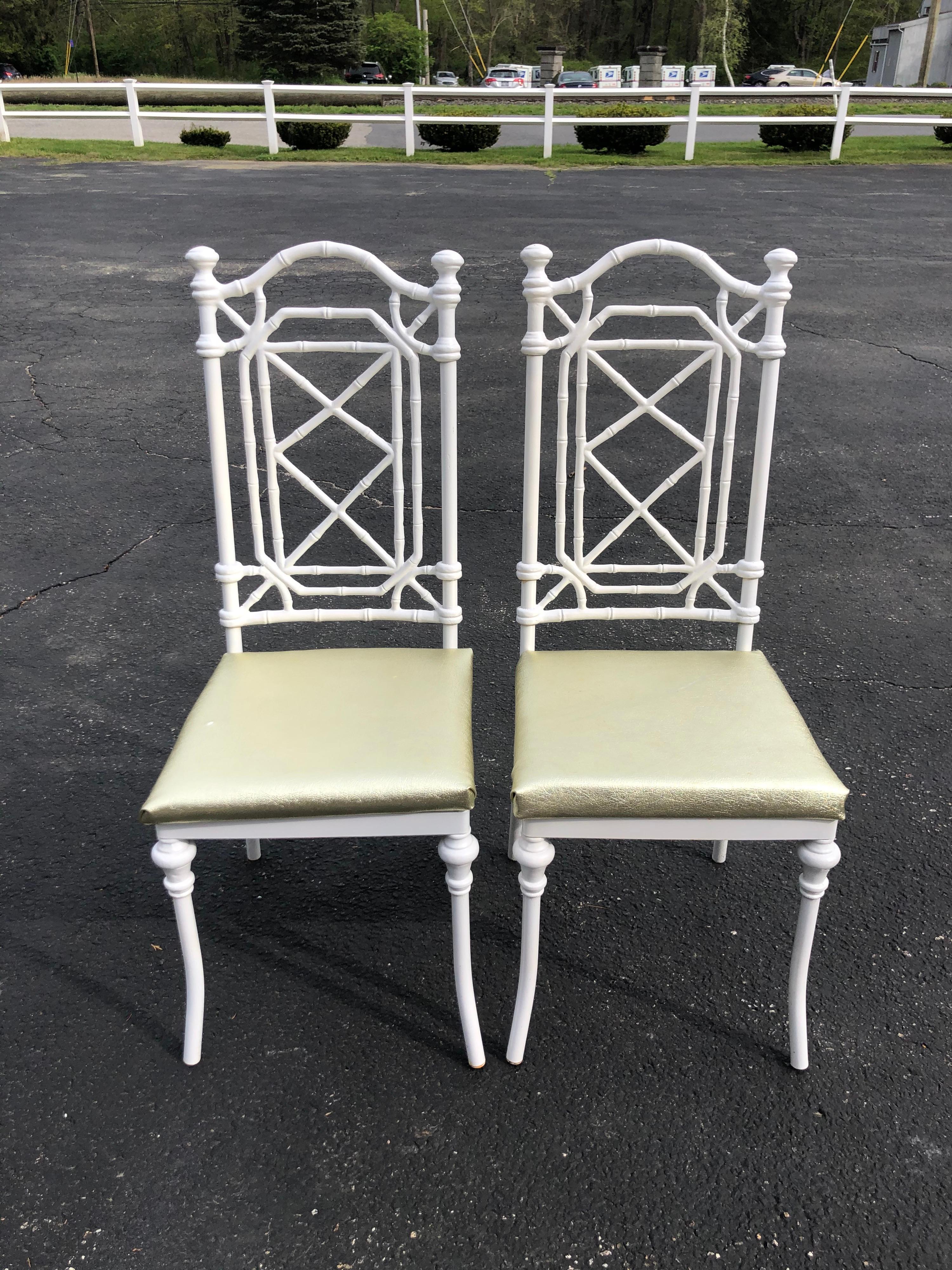 Pair of Hollywood Regency white faux bamboo chairs by Warren Kessler. Gorgeous fretwork to this stunning pair of chinoiserie chairs. Recently recovered in a gold lame' vinyl for use outdoor. But seats unscrews to easily be recovered in what you want.