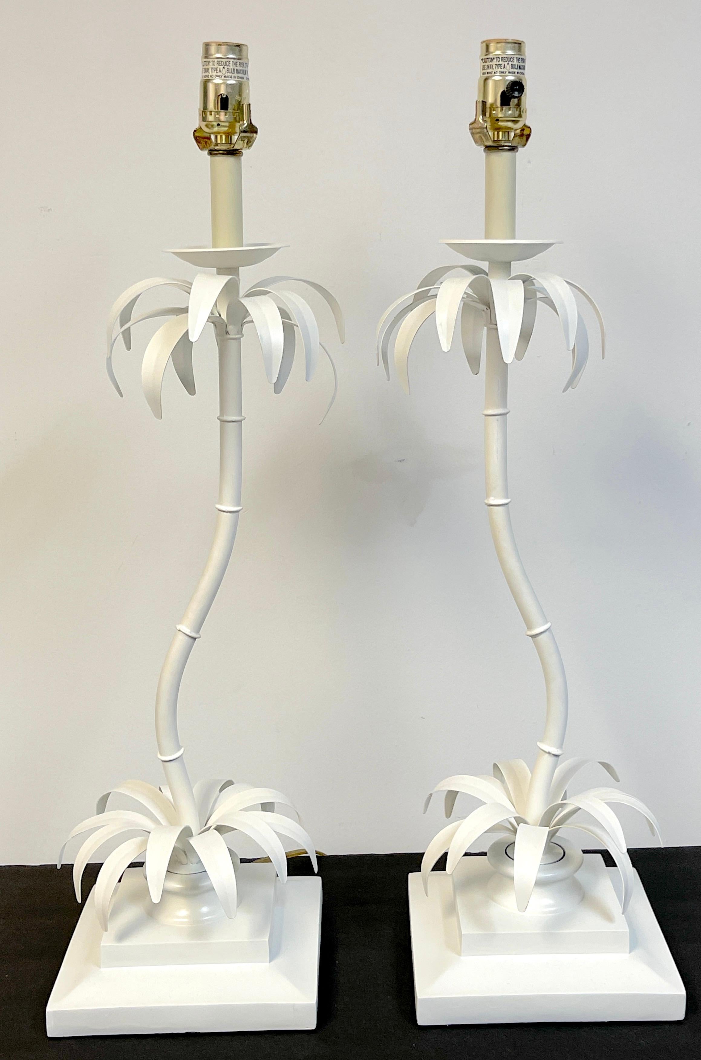 Pair of Hollywood Regency white lacquered contoured palm tree lamps 
Italy, Circa 1970s
A whimsical pair of Palm tree lamps, each one a unique design with palm leaves at the top and bottom, joined with slightly contoured palm tree trunk, raised on