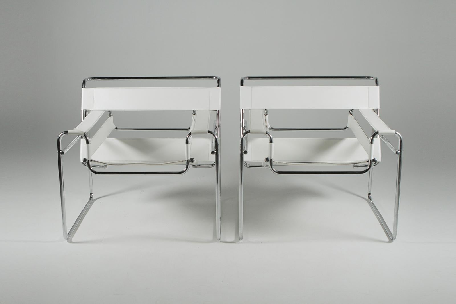 Glamorous pair of Italian Wassily style Mid-Century Modern club chairs in the manner of Marcel Breuer in a dreamy white leather and chrome ensemble.

 