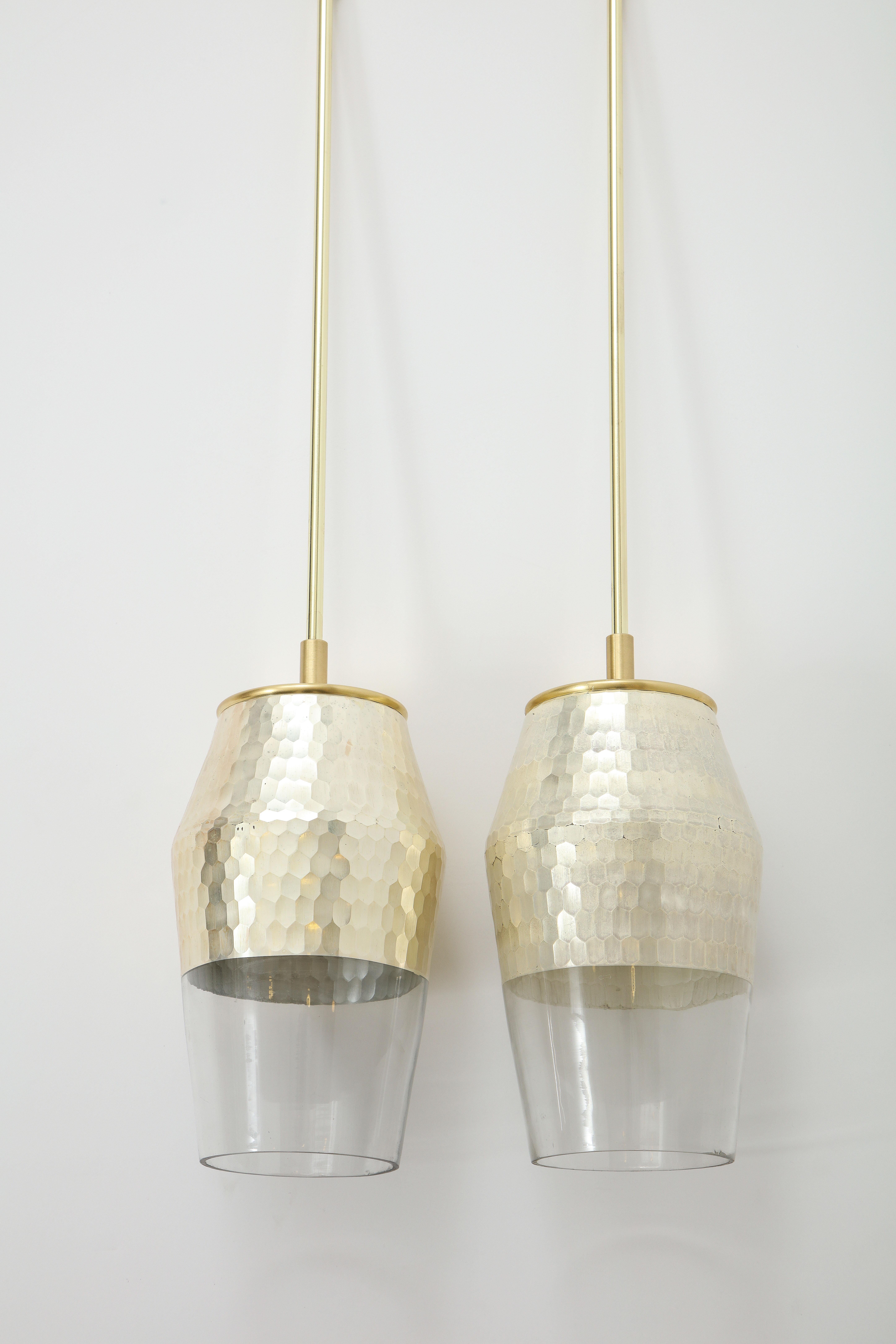 Pair of pendant lights with a Honeycomb textured finish and glazed silver leaf interior.
The polished brass pendants have been newly rewired and take a standard size light bulb
with a 60 Watt maximum.
The rod is 16