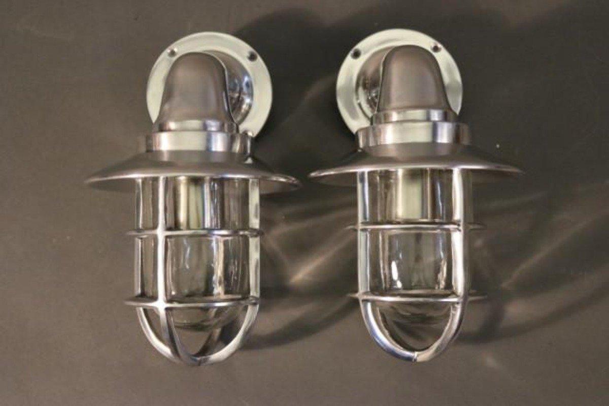 Two solid polished aluminum ships lights with hoods, protective cages, glass jars, and etc. Dimensions: 7