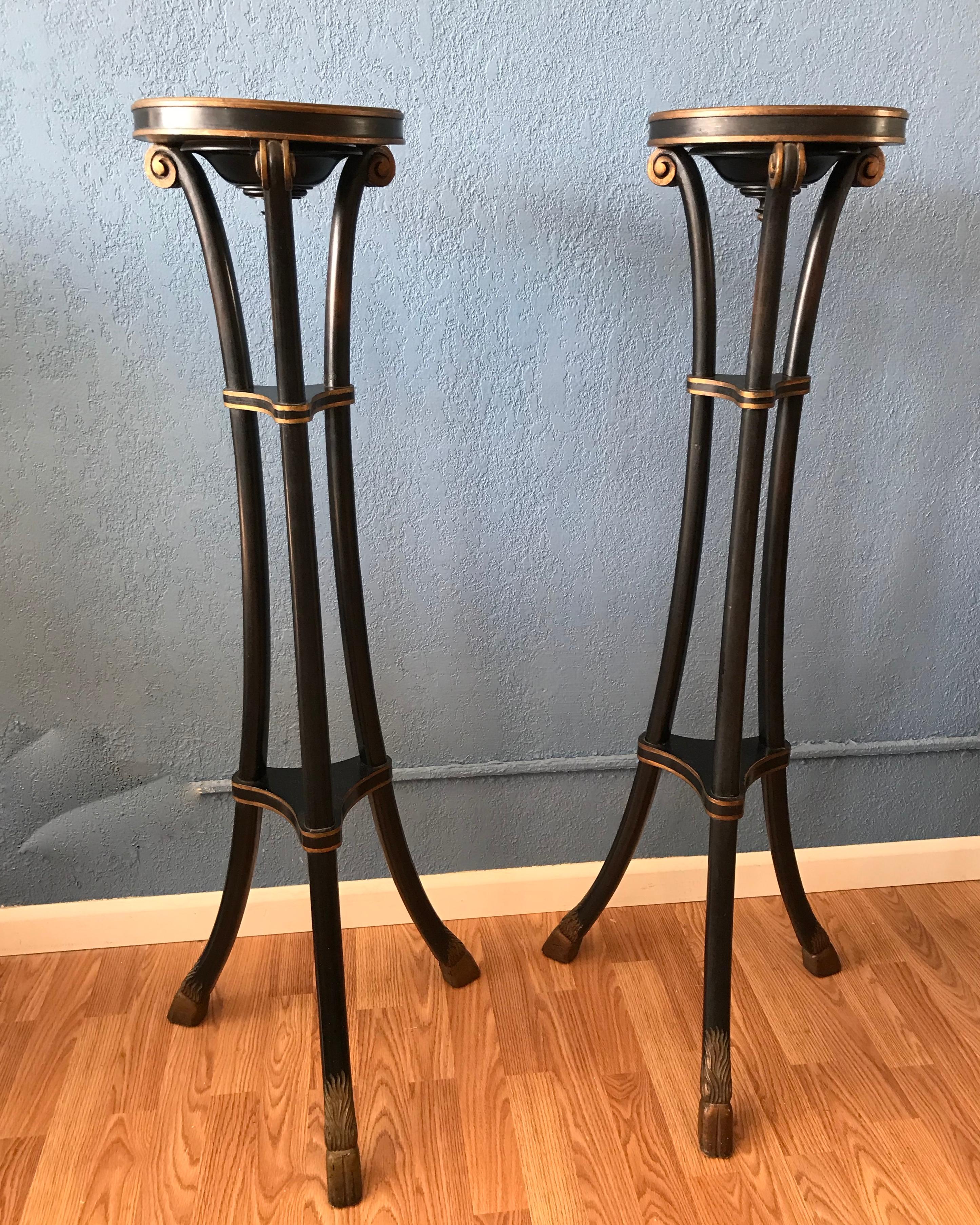 Finished in black with gilt accented horses hoofs,
the stands are dramatic and unusual in form.