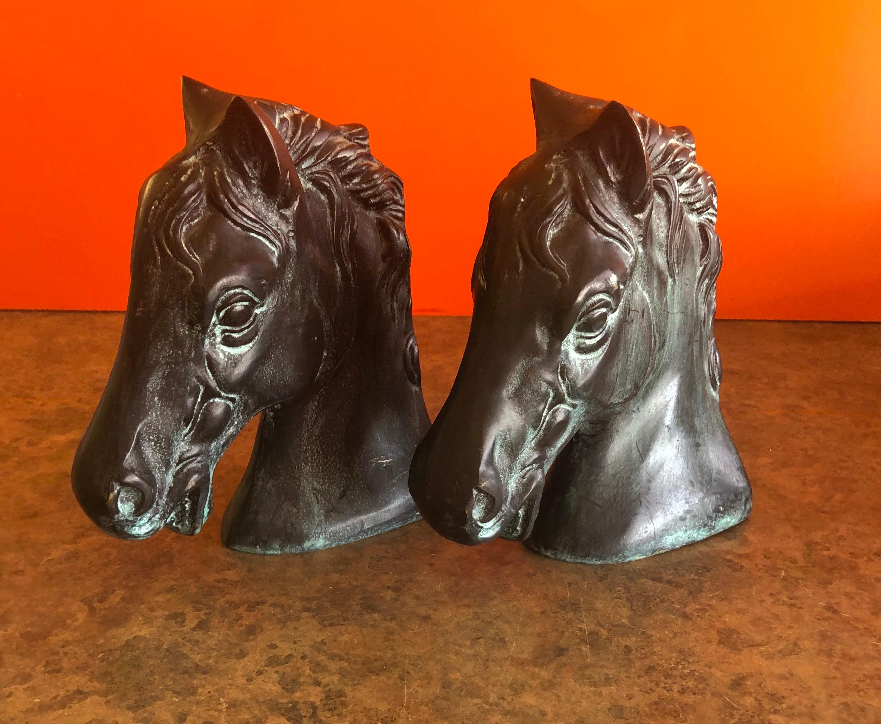 Classic pair of horse head bookends in bronze, circa 1970s. The pair are quite heavy and filled with sand; really nice patina! #1143.