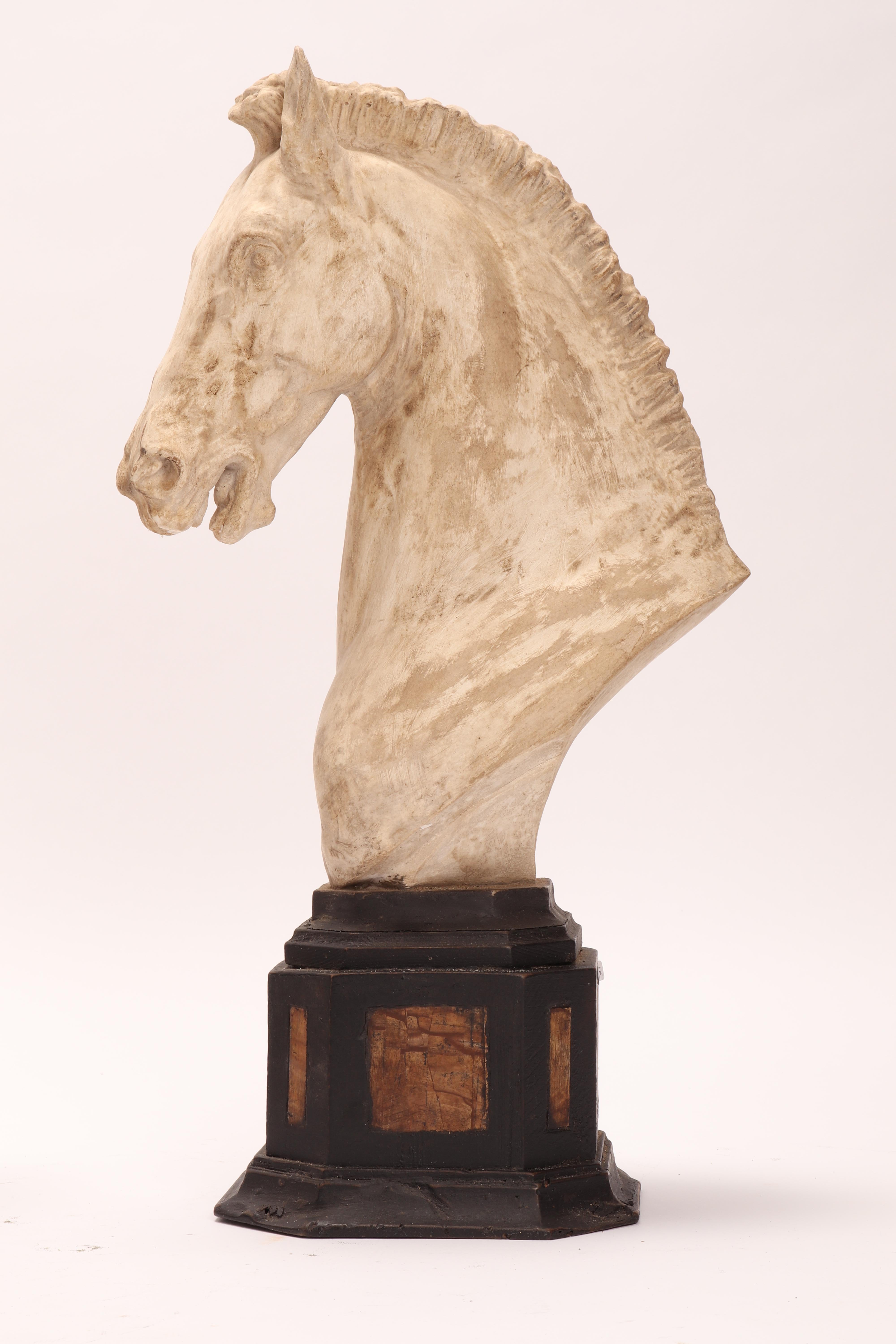 Pair of horse’s heads. Over the octagonal wooden black painted base is set a cast of a horse head. Along the sides of the plinth base, there are 8 Paesina stone (figured stones) slabs. The cast for drawing teaching in Academy. Italy, circa 1870.