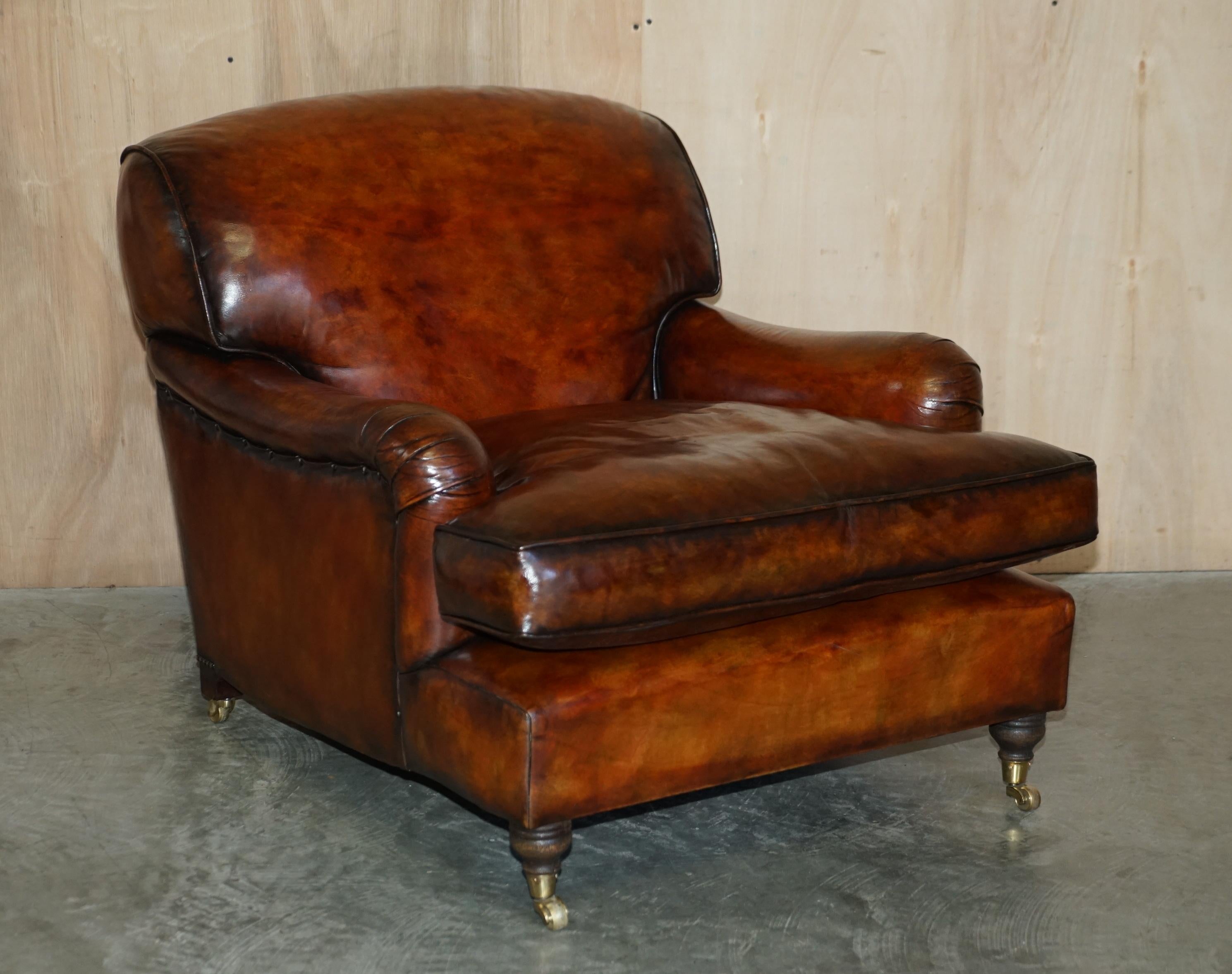 We are delighted to offer for sale this sublime large pair of fully restored Howard George Smith style Signature Scroll Arm cigar brown leather armchairs with oversized feather filled cushions.

These are just about the finest armchairs available