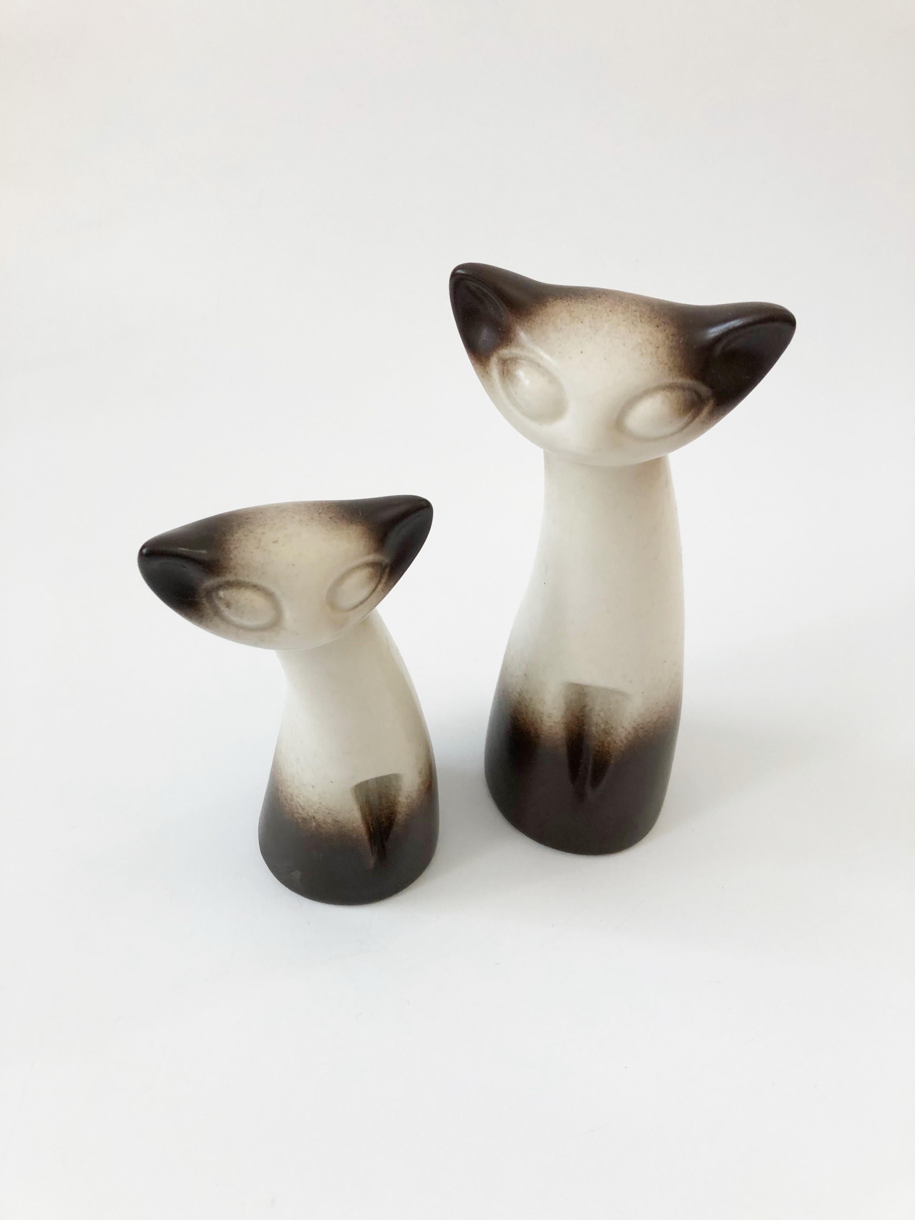 A wonderful pair of pottery cats by Howard Pierce. Nice larger size, each cat is a different height. Beautiful signature matte glaze that fades from dark brown to off-white. Each is marked 
