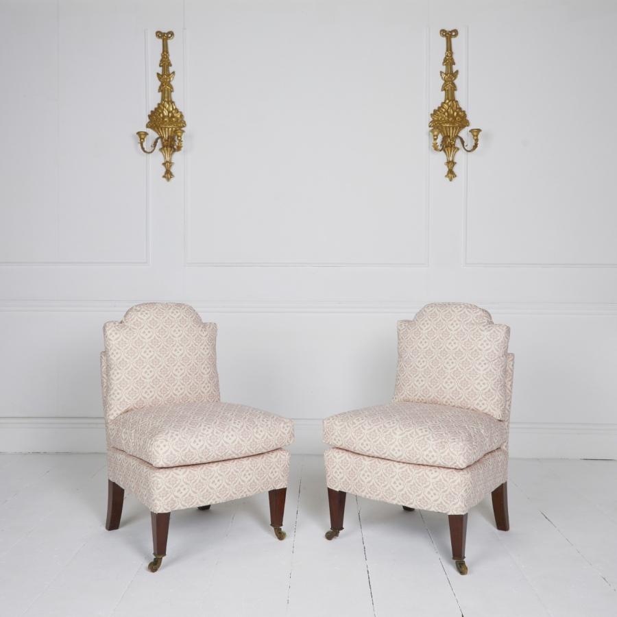 Howard & sons smallest bedroom chairs covered in pink H&S organic ticking, standing on polished tapered legs and stamped castors.
Traditionally upholstered with siege de duvet trapped cushions filled with ethically sourced French duck feather and