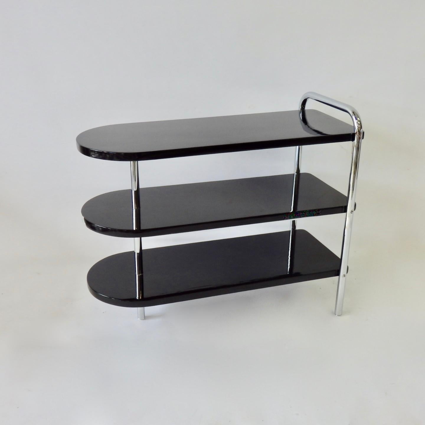 Pair of Wolfgang Hoffman for Howell Machine age Moderne side tables. Recently chromed and freshly black lacquered.