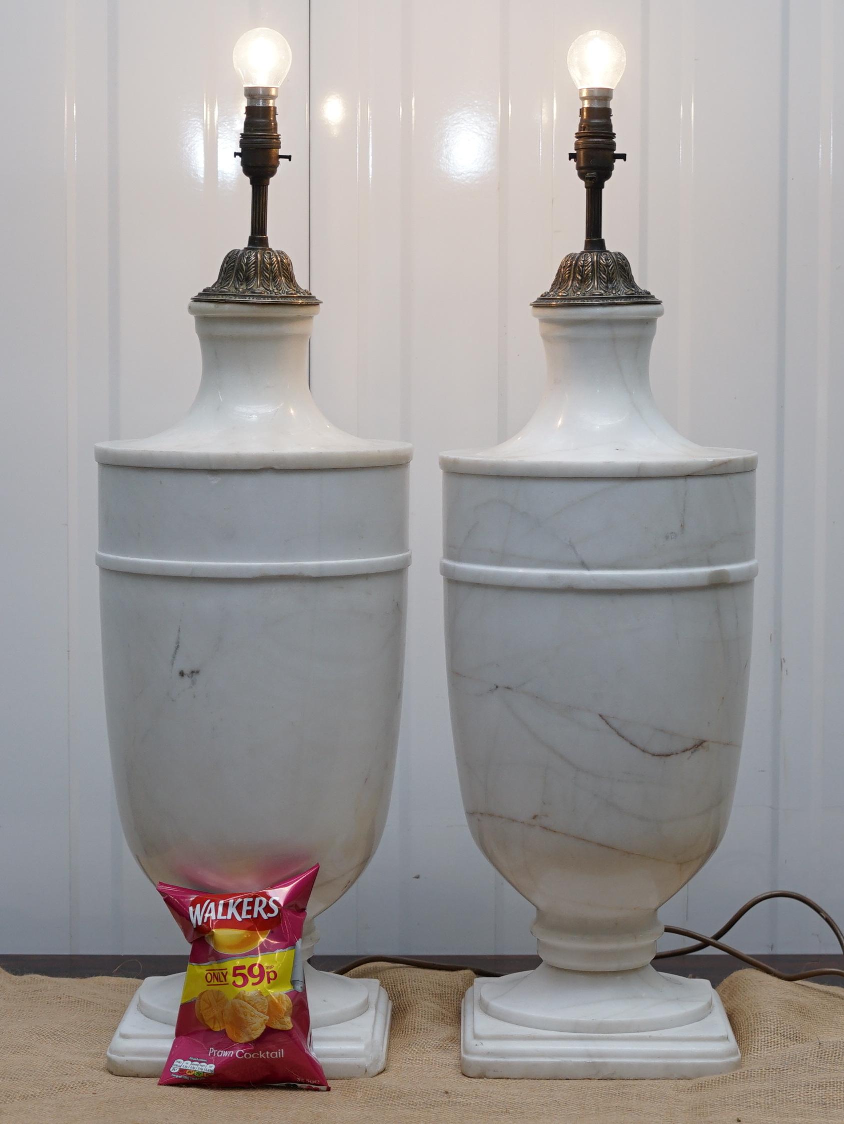 We are delighted to offer for sale this pair of huge solid white Italian marble urn table lamps.

These lamps are monumental, they must weigh 50kgs each, they have the original bronzed fittings however they have been fully rewired and PAT