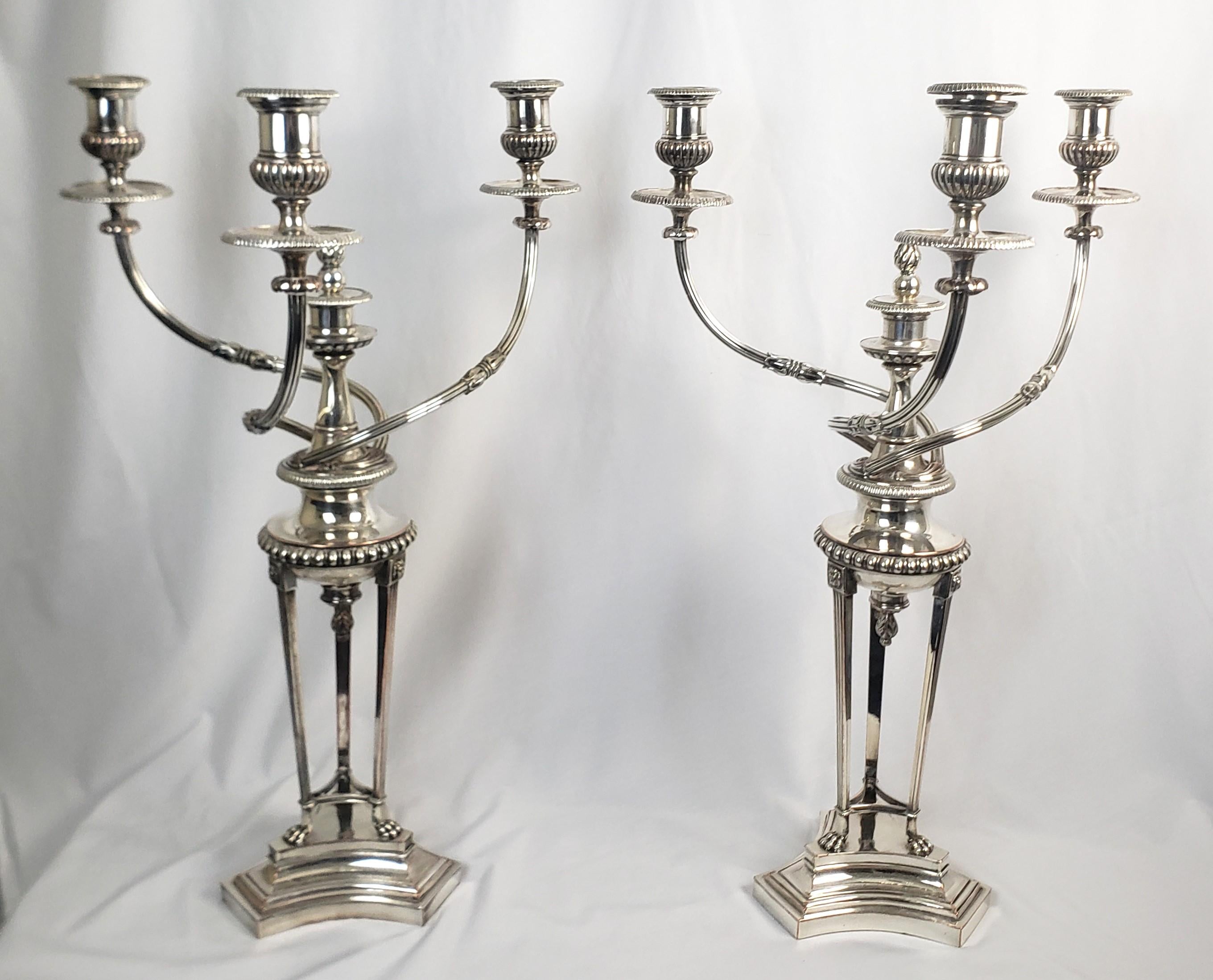 This pair of large and substantial silver plated candelabras were made by the renowned Matthew Boulton on England in apprximately 1810 and done in a period Regency style. The pair are both clearly marked with the Boulton twin suns hallmark on the