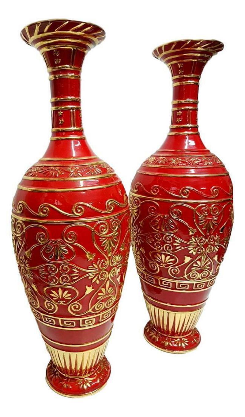 Pair of huge Italian-made ceramic vases from the 1960s, made of red and gold polychrome ceramic, with relief motifs, perforated at the top and bottom for the positioning of glazing beads

They were in fact placed in the living room of a house as a