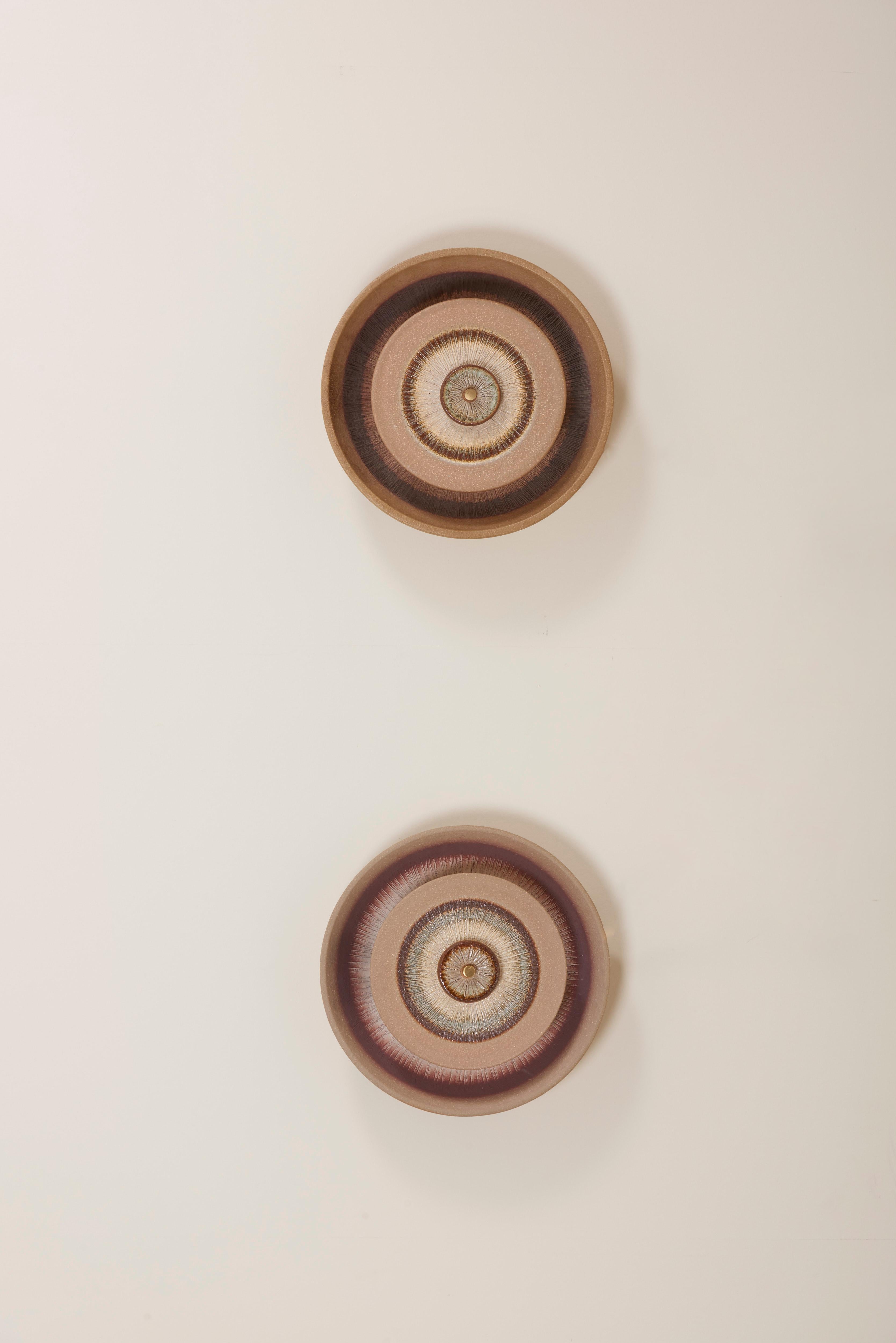 Pair of Danish ceramic wall lights from the 1960s designed by Noomi Backhausen & Poul Brandborg for Søholm, Scandinavian Style. The lights consist of ceramic discs with a back light. 1 x E14 bulb each.

To be on the safe side, the lamps should be