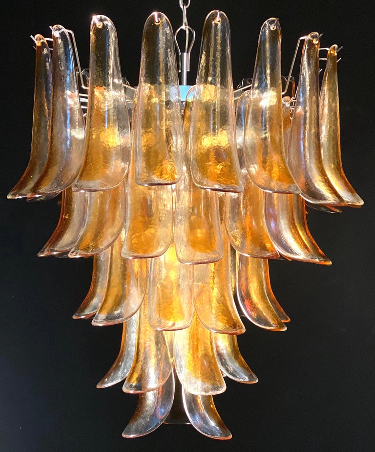Pair of huge Italian vintage Murano chandelier made by 52 clear amber glass petals supported by a chrome frame.
The clear amber color of the glasses create a fabulous warm light effect.
Period: 1970s
Dimensions: 55.10 inches (140 cm) height with