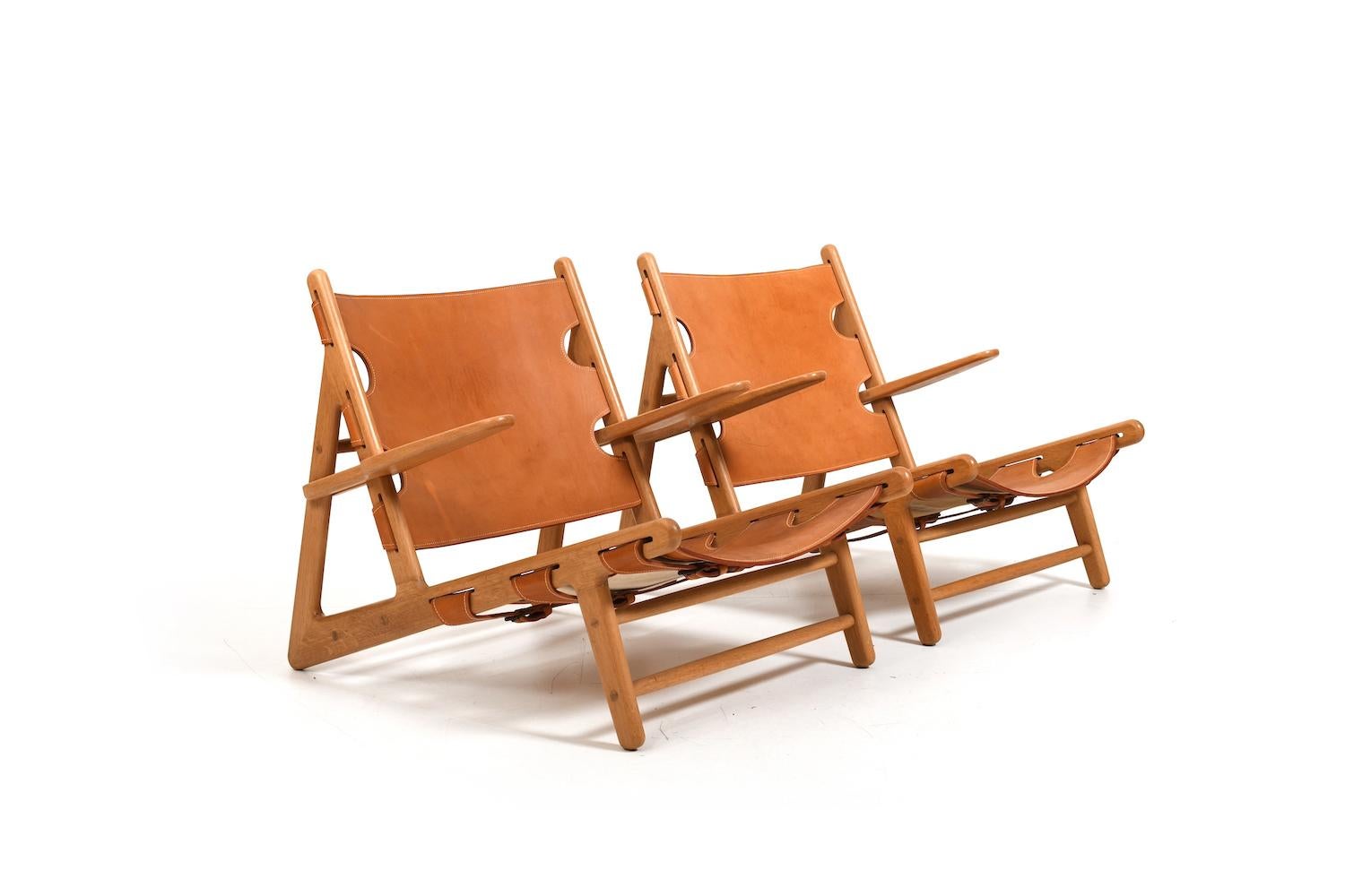 Pair of Børge Mogensen hunting chairs , model 2229 for Fredericia Stolefabrik. Made in oak and natural leather. Produced 1970s. With nice patina. The chairs were professionally stored for a long time because the previous owner was less able to use