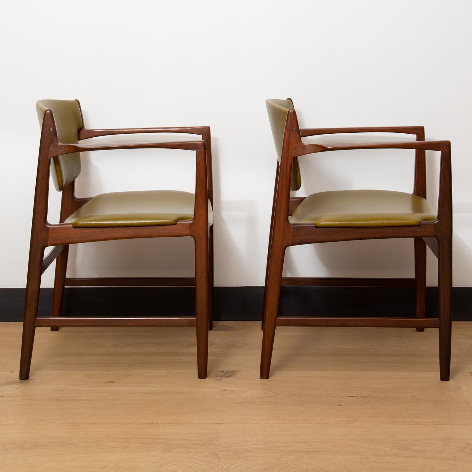 A pair of model 4513 teak wood armchairs by Danish designer Ib Kofod Larsen for British furniture manufacturer G Plan. Produced during 1960s.
These chairs have been fully restored and reupholstered in a beautiful olive colored Italian leather.