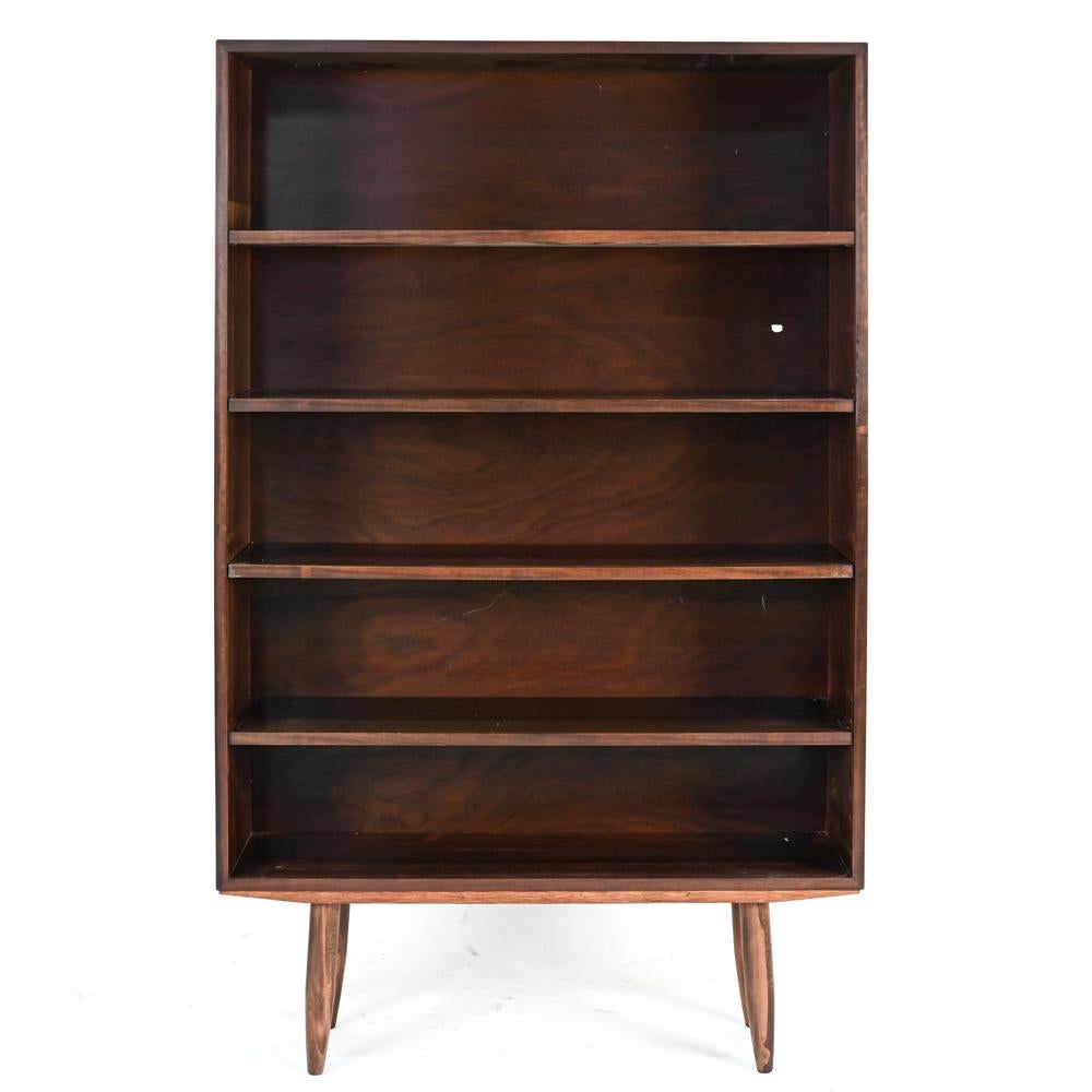 A Danish mid-century rosewood bookcase cabinet pairing designed by Ib Kofod-Larsen.