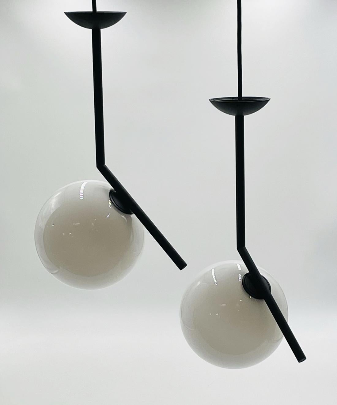 The IC S Pendant Light from FLOS is a case study in balance. After watching a video clip of a contact juggler, designer Michael Anastassiades was inspired by the skill it took to spin and move the set of spheres around the juggler's body. His