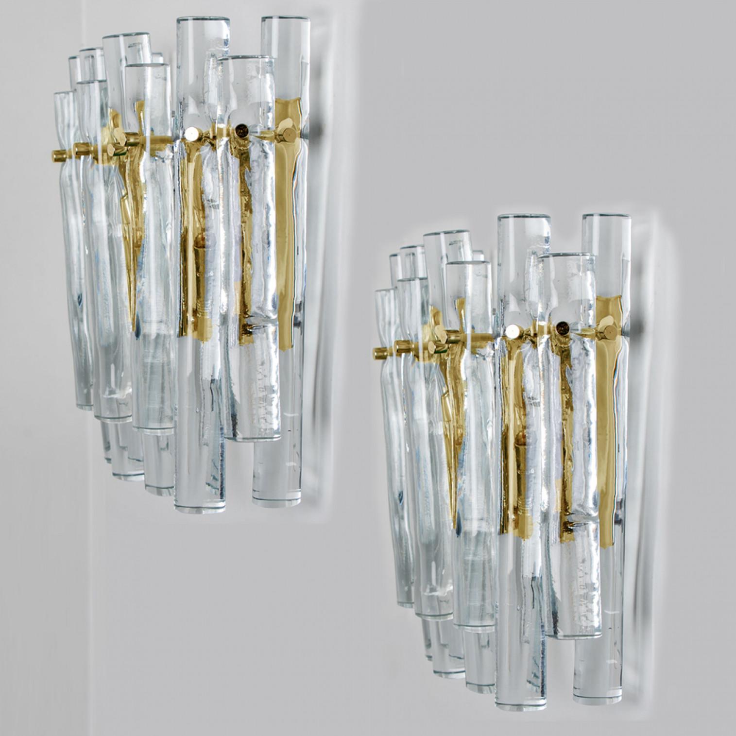 Ice glass and brass wall sconces by the famed maker, Kinkeldey, Germany, Europe. Very elegant light fixtures, comfortable with all decor periods. The crystals are meticulously cut in such a way that radiate the light of the bulb in different