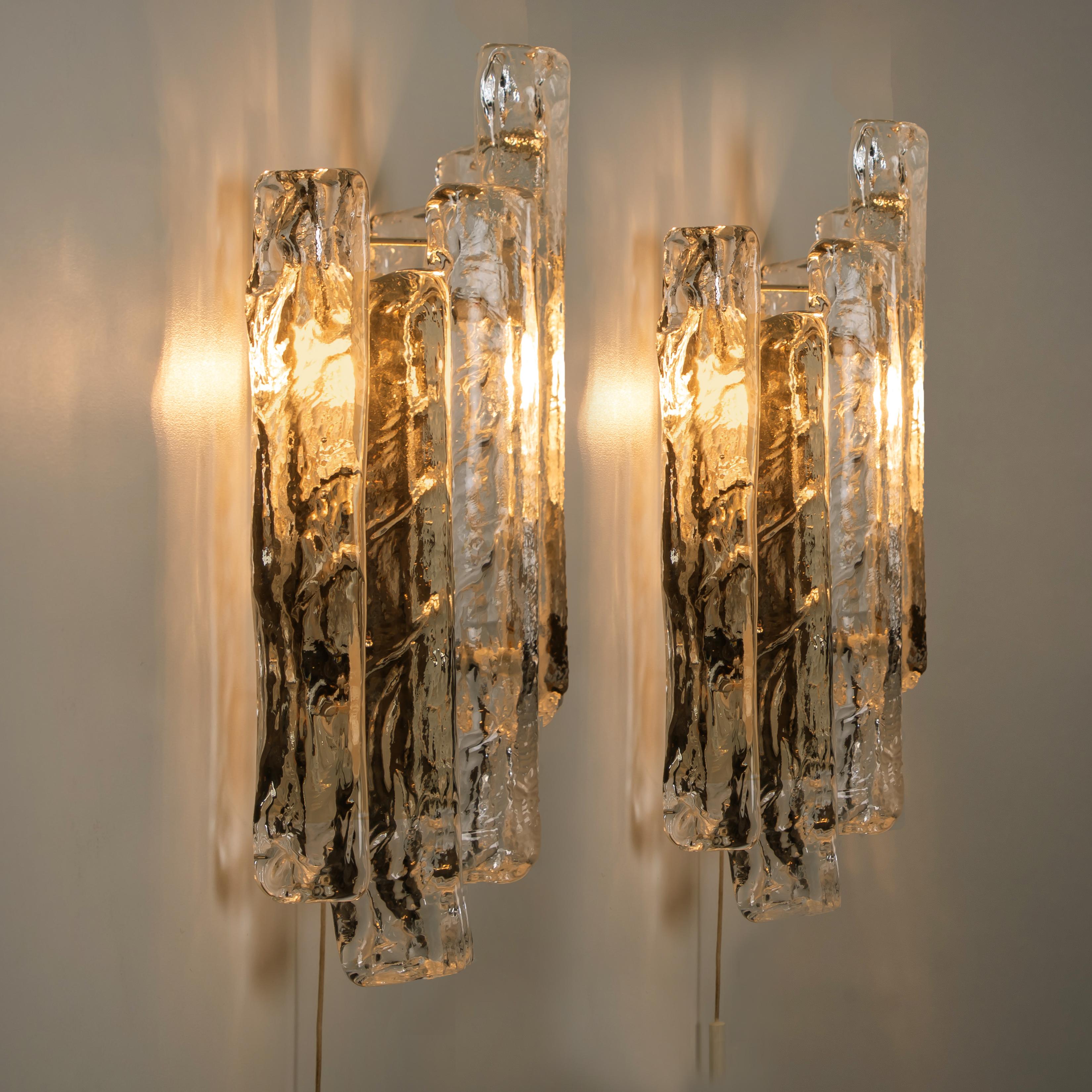 Pair of elegant modern high-end large brass (brushed) wall lights or sconces, Austria in the 1970s. Lovely design, executed to a very high standard. Each wall light has four solid ice glass sheets dangling on it. Clean lines to complement all