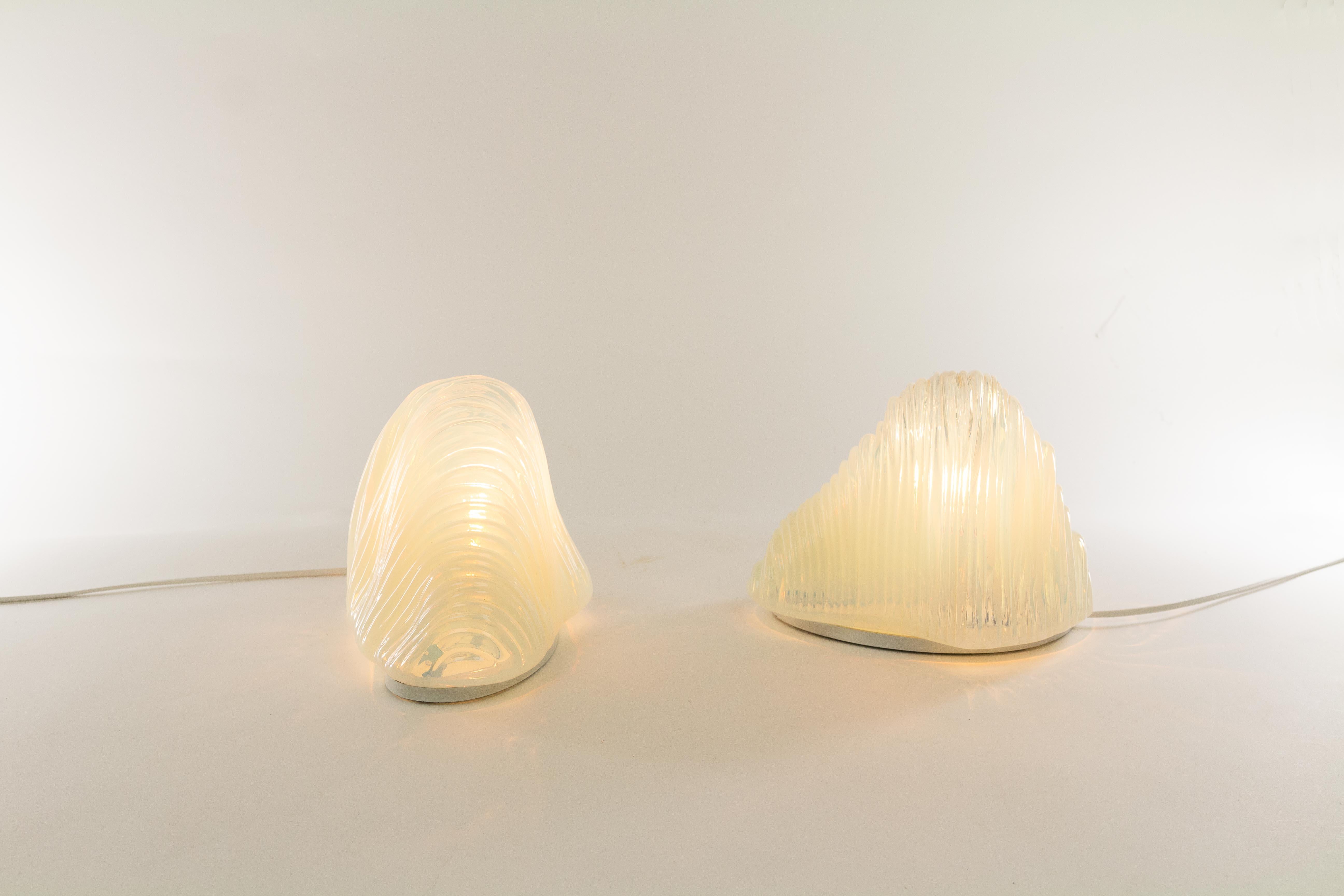 Original table lamps model LT 301 or Iceberg designed by Carlo Nason in the 1960s for A.V. Mazzega. 

The lamps are made of curved Murano glass that provide a wonderful light effect. Both lamps have a lacquered metal base which include a E14