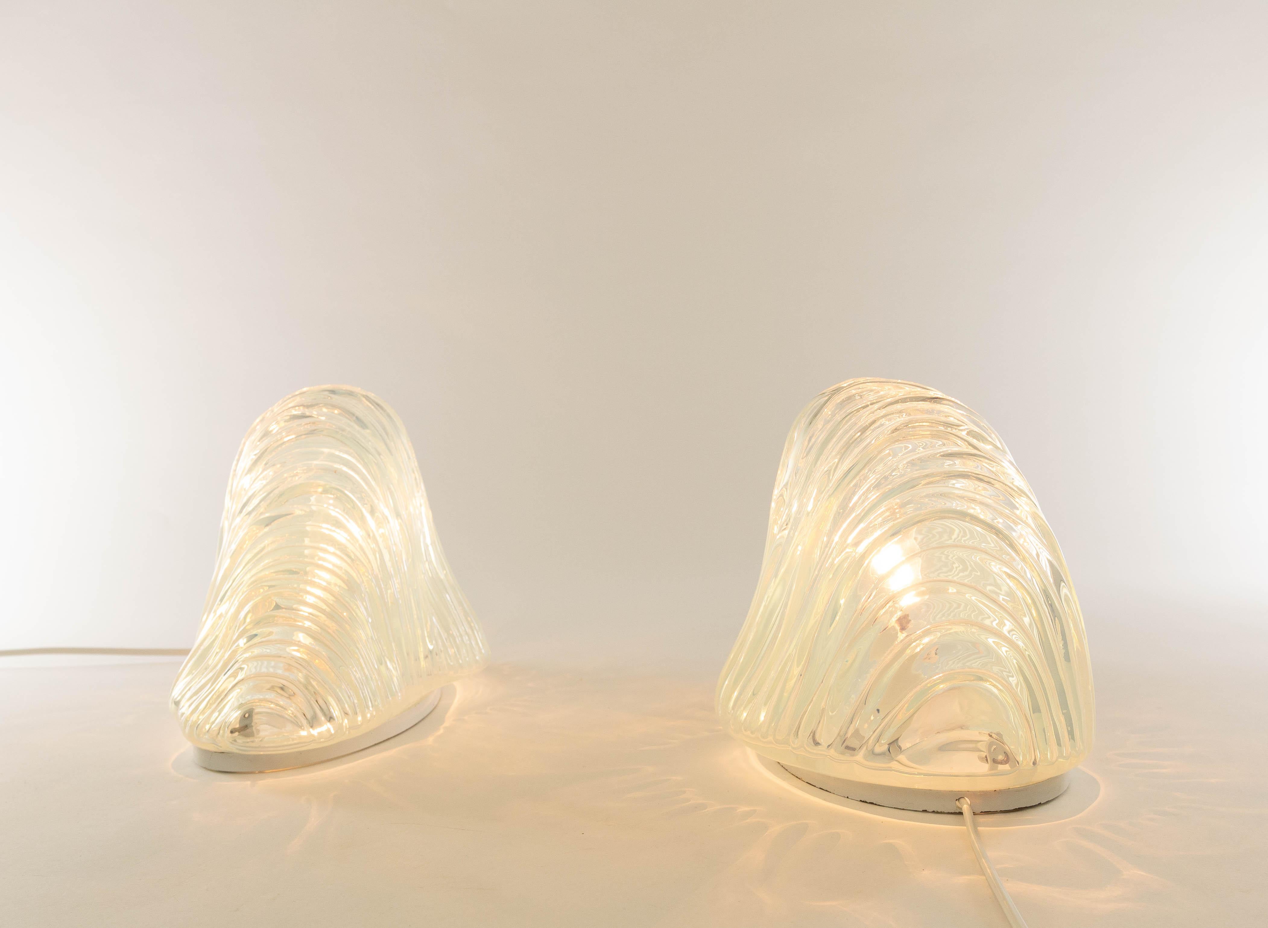 Original pair of iceberg table lamps or model LT 301 designed by Carlo Nason in the 1960s for A.V. Mazzega.

These table lamps are made of curved Murano glass that provides a wonderful light effect. The lacquered metal bases include E14