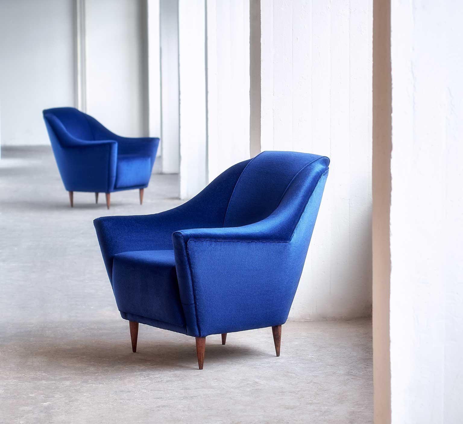 These sumptuous armchairs were designed by Ico Parisi in 1951. This particular model was manufactured by Ariberto Colombo in Cantu, Italy. 
The pronounced curves and lines of the design give the chairs a modern and elegant feel. The chairs have been