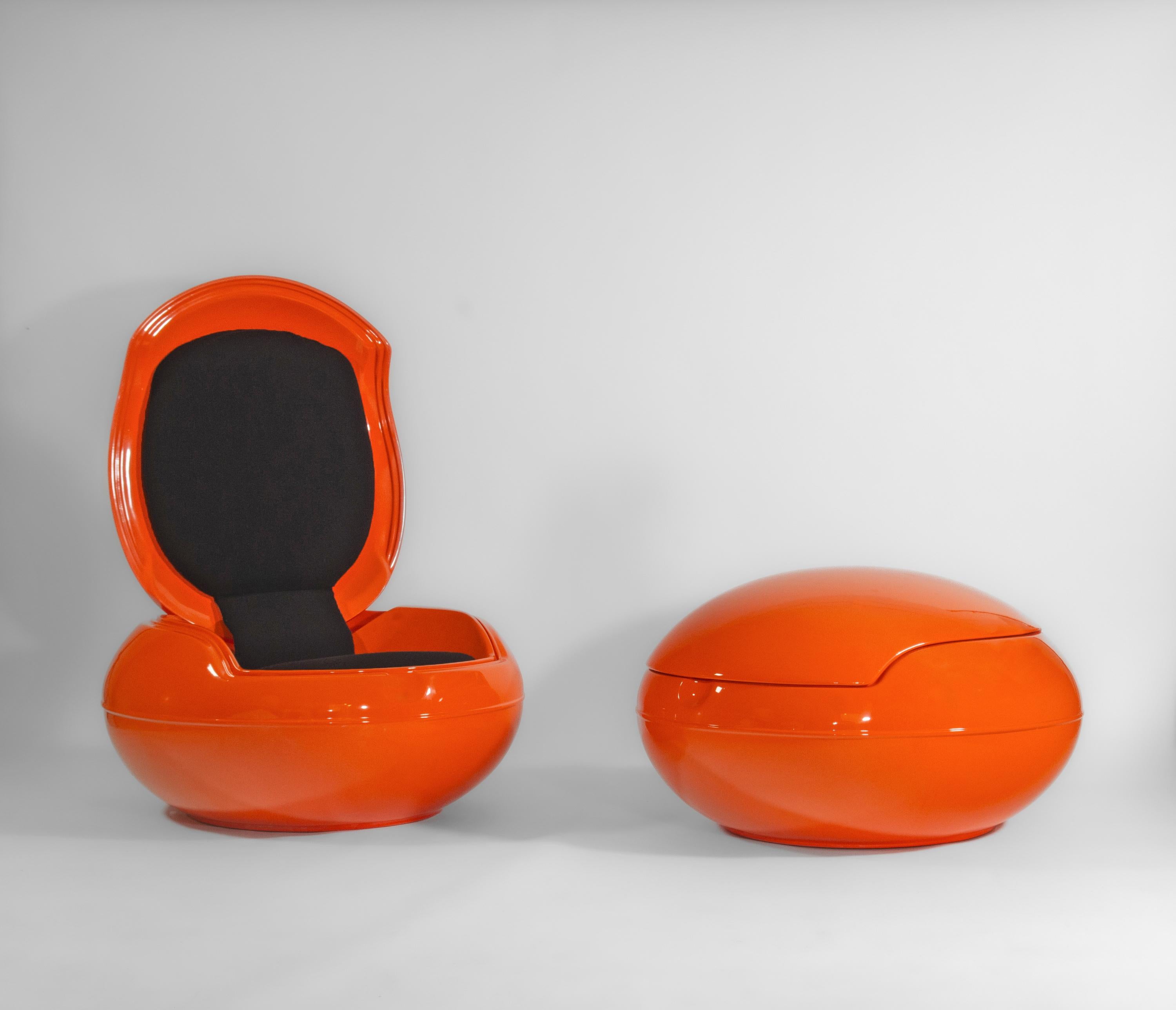 Pair of Peter Ghyczy Garden Orange Egg Chairs Circa late 1960s/early 1970s.

The egg chairs with a space age, UFO-like form, in brightly coloured orange finish and black cloth seating. They have been resprayed to their original colour, and look