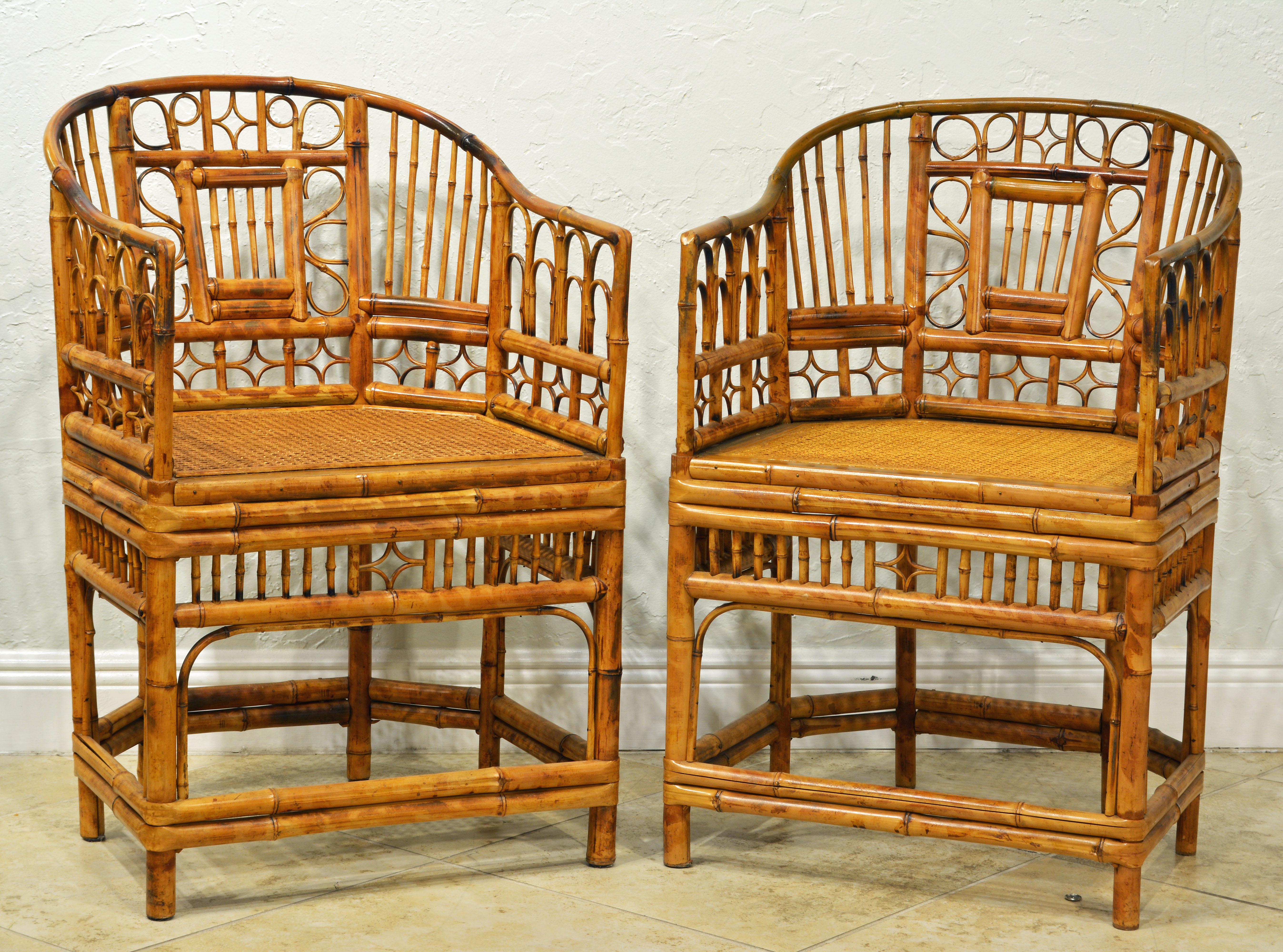 Rising on six legs this pair of intricately crafted iconic armchairs with cane seats feature bamboo frames and Chinese themed bamboo open work inspired by Chippendale design. They come with new cushions covered with Ralph Lauren Voyager fabric in