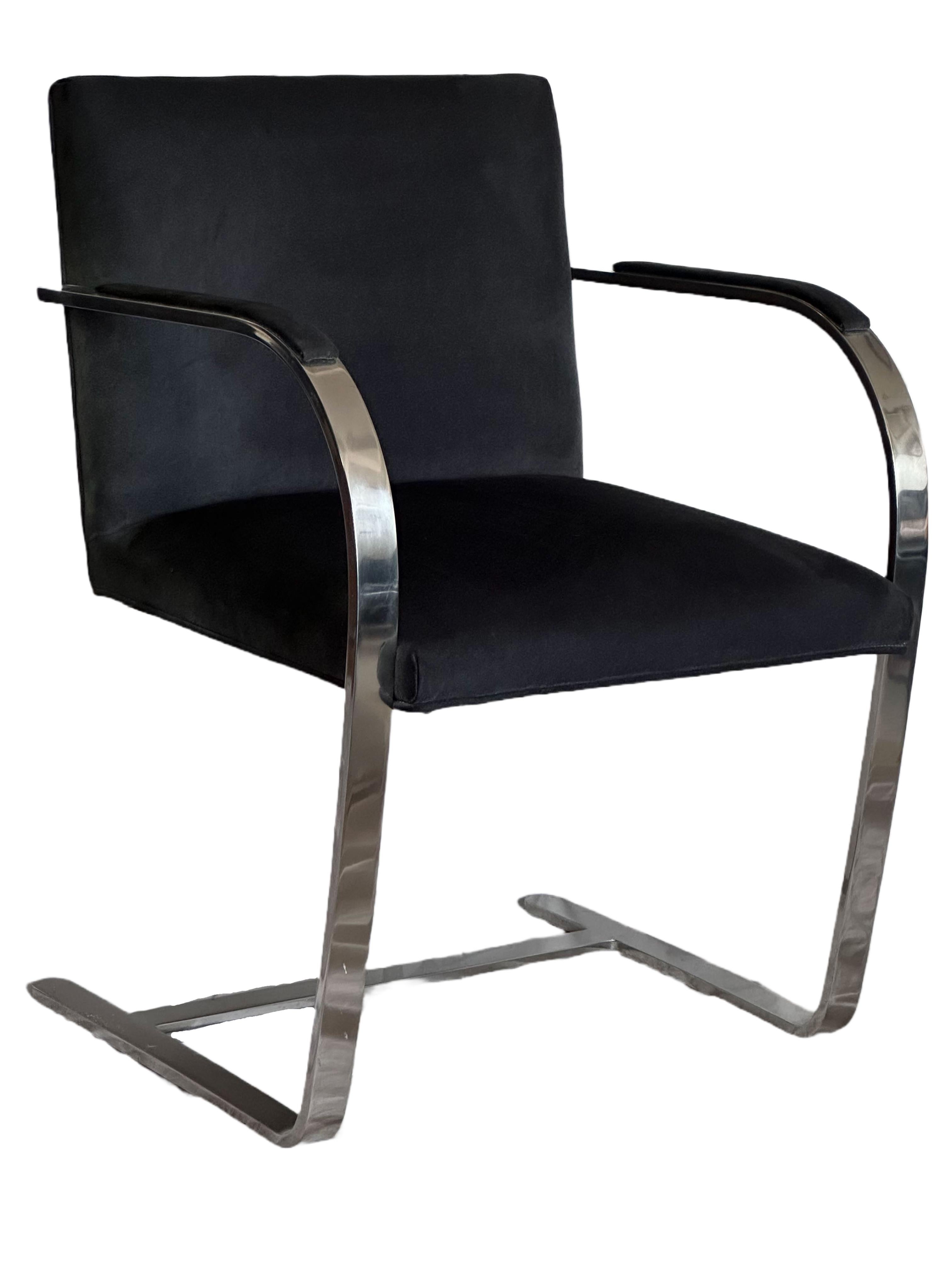These are a vintage pair of the iconic BRNO chair (model 255) designed by Mies van der Rohe for Knoll.

The flat bar frame is polished chrome (plated), and the seat is black suede form the period. The chairs are barely used and in excellent