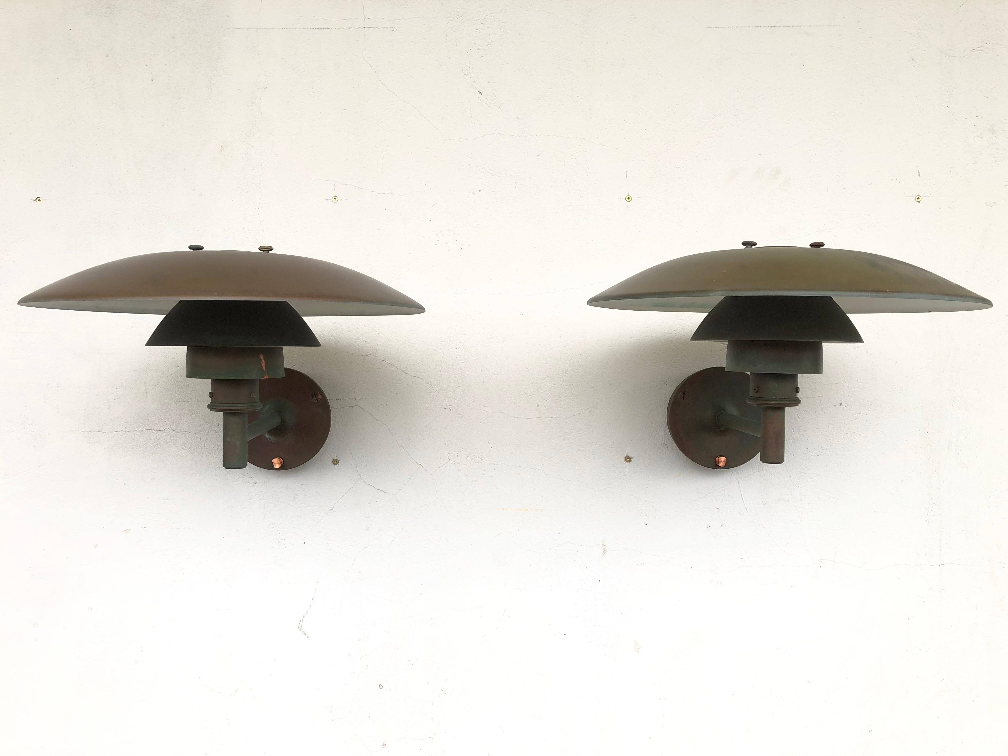 A pair of iconic Poul Henningsen copper wall lamps PH 4.5 made in Denmark by Louis Poulsen from the 1980s.
This iconic lamp was first designed in 1966 and has been a Classic ever since
These lamps are in original condition with a lovely patina and