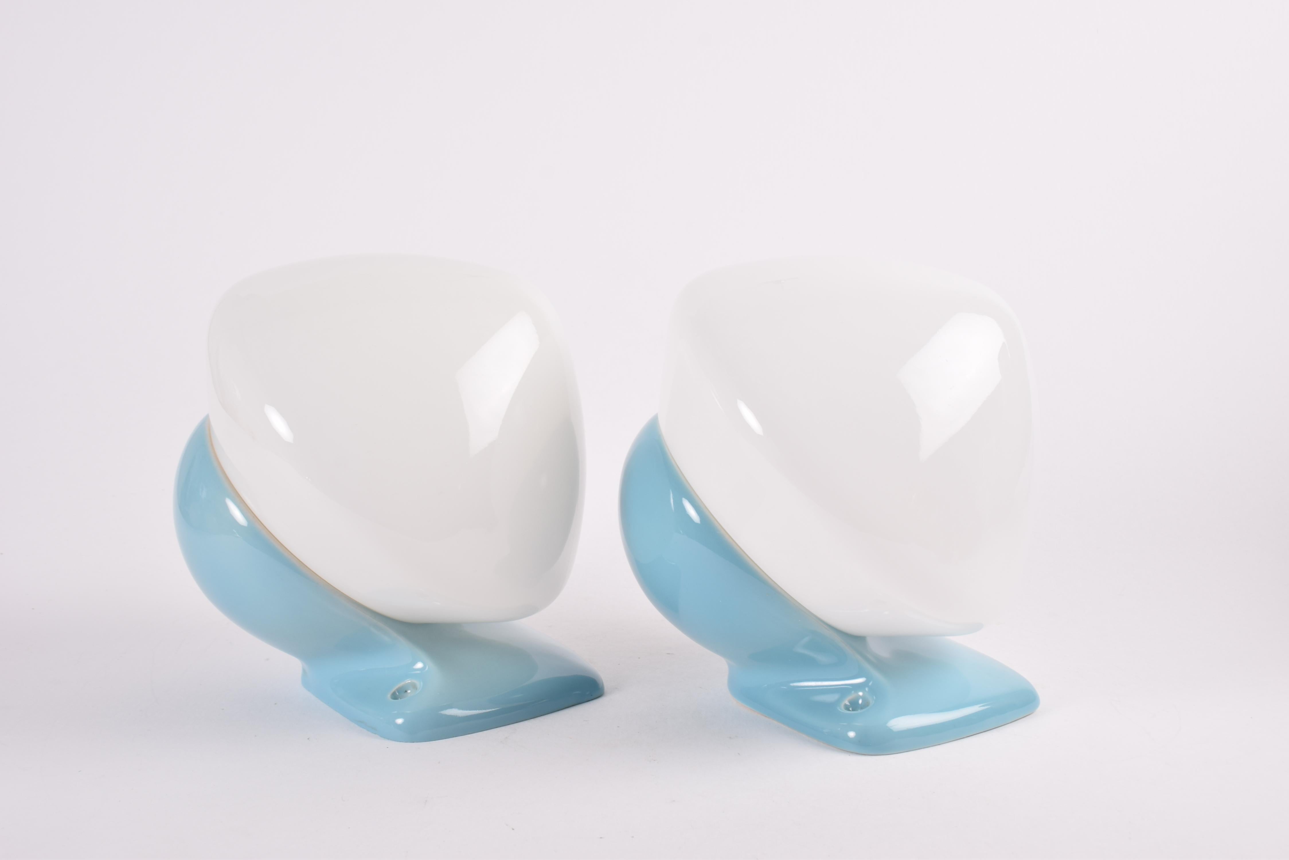 Pair of two original vintage wall sconces from Ifö, Sweden, made circa 1950s to 1960s. They come in a rare blue color version and the glass screens are made from white opaline glass. Perfect to be mounted on each side of a mirror in the