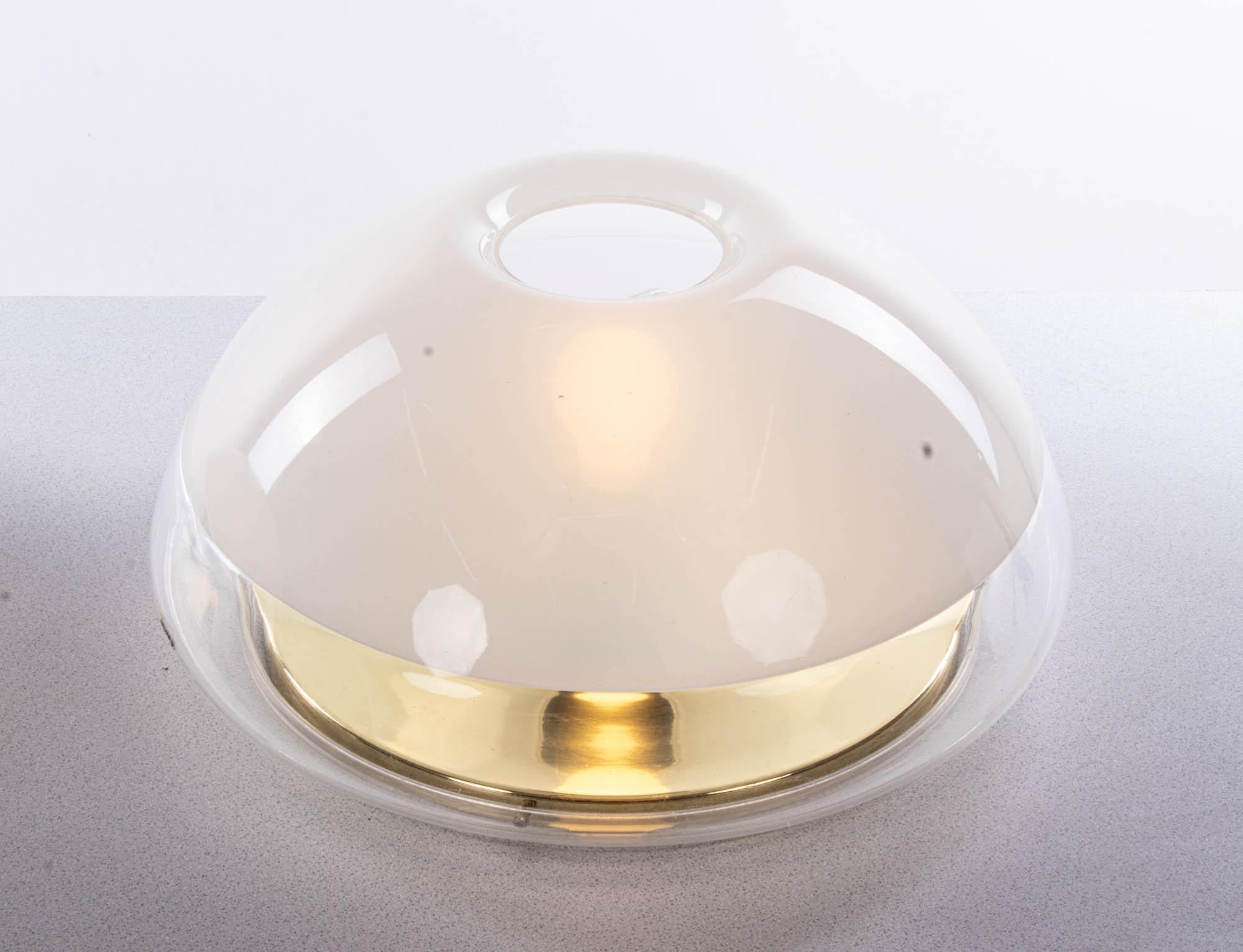 Elegant pair of space age wall and ceiling lights with white and clear plastic lampshades on a brass tulip frame. Designed and manufactured by iGuzzini, Italy in the 1970s. 

Measures: diameter 17.7