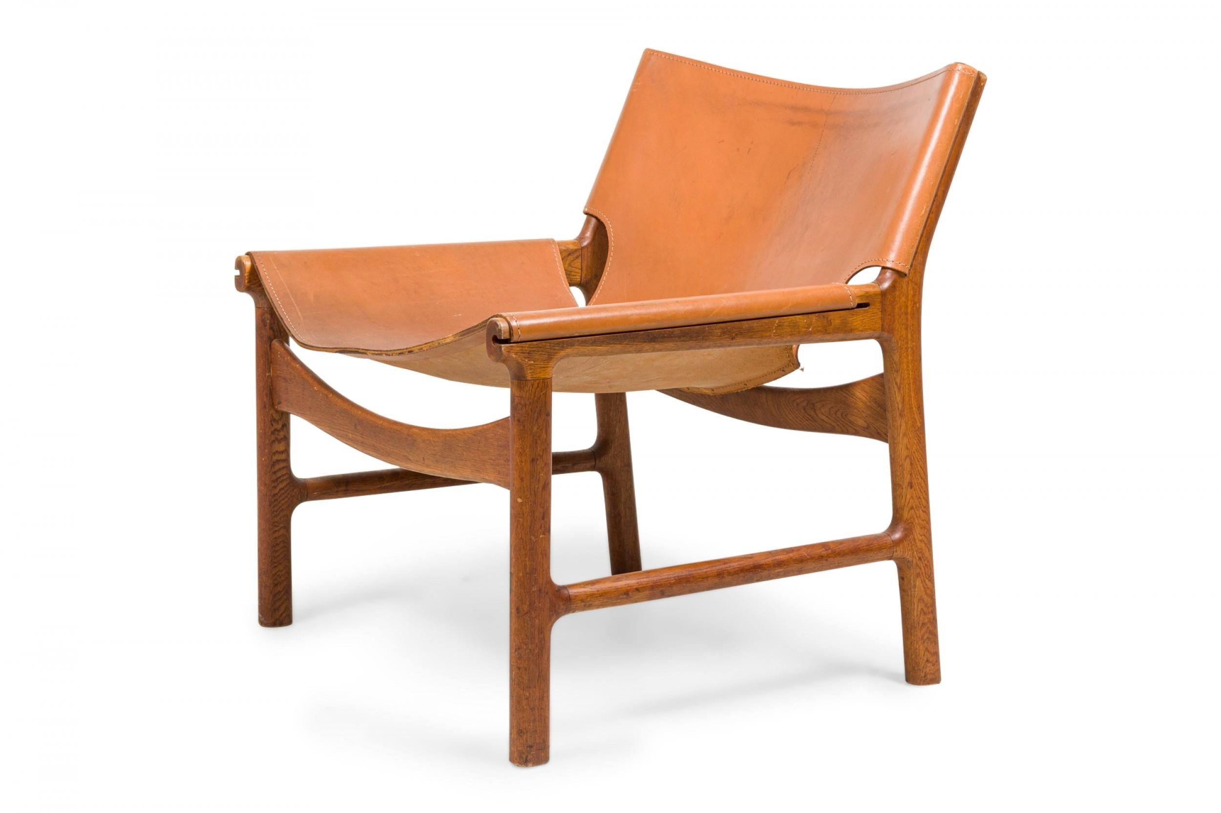 Danish Pair of Illum Wikkelsø Caramel Leather and Oak Sling Design Lounge Chairs