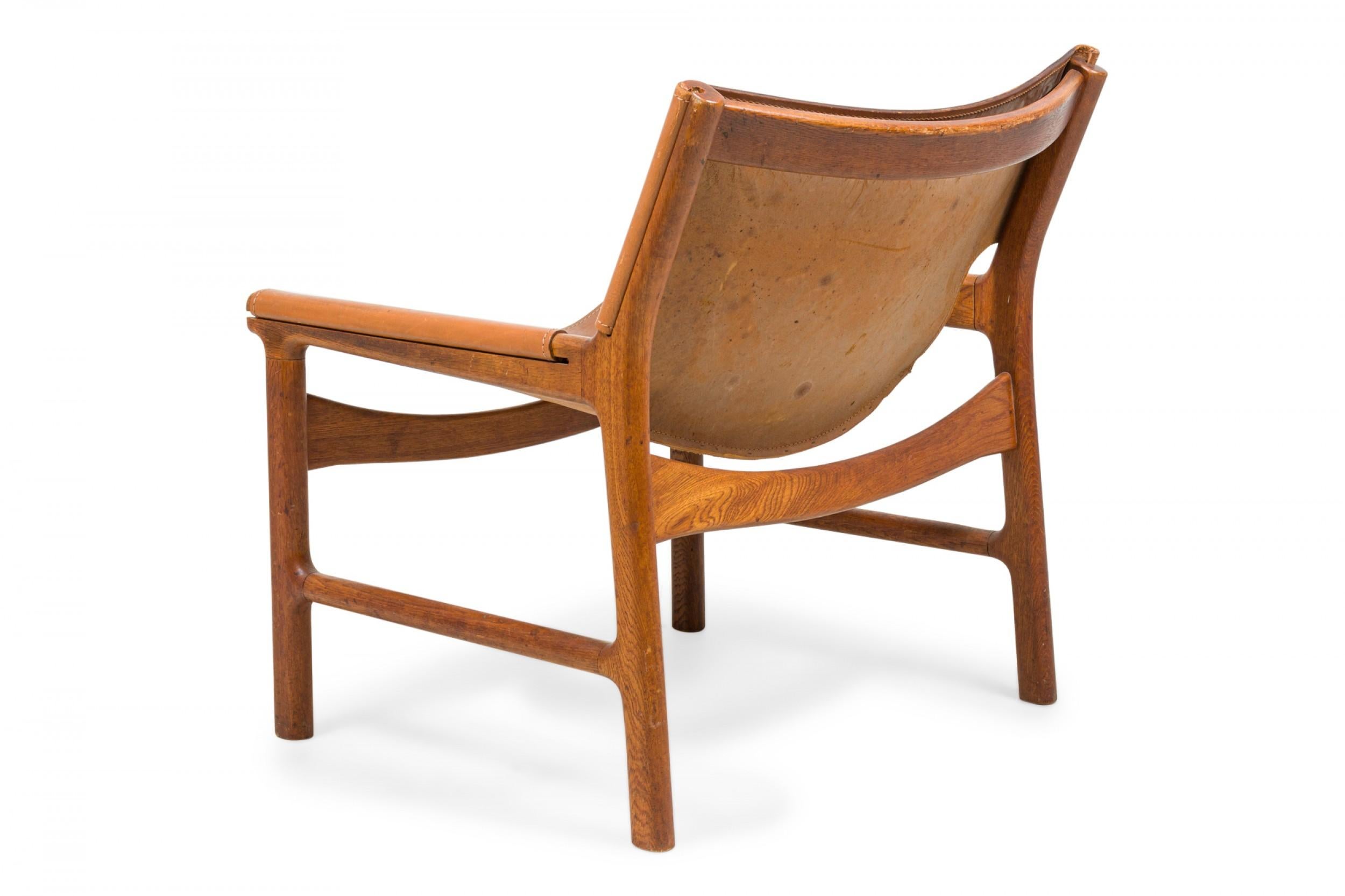 20th Century Pair of Illum Wikkelsø Caramel Leather and Oak Sling Design Lounge Chairs