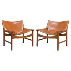 Pair of Illum Wikkelsø Caramel Leather and Oak Sling Design Lounge Chairs